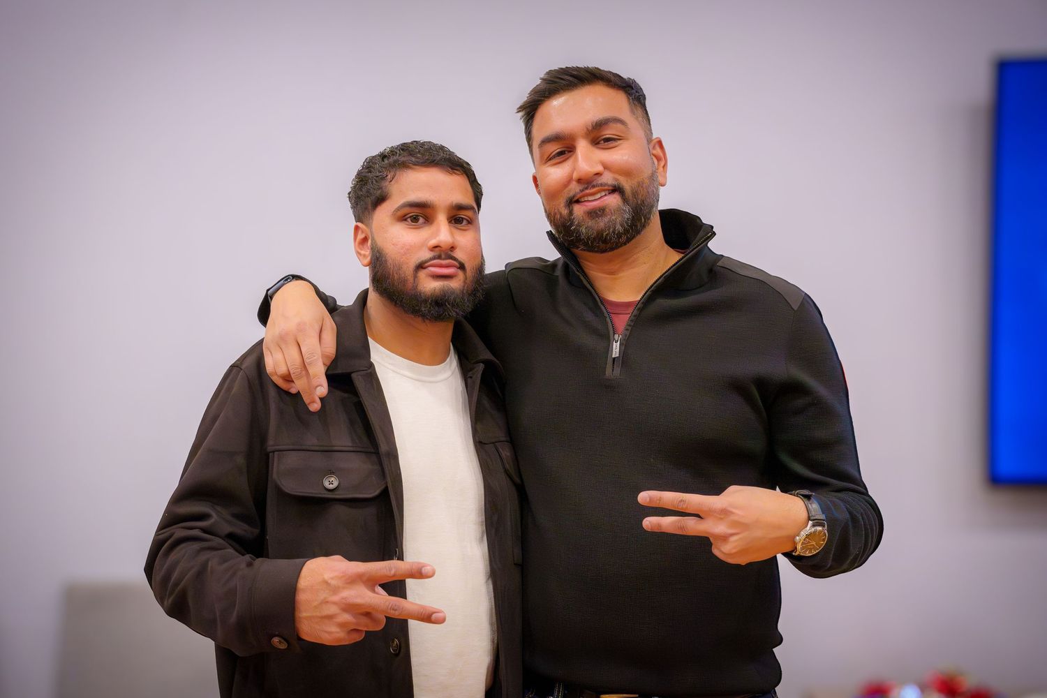 Friends posing and making gestures at an indoor party event.