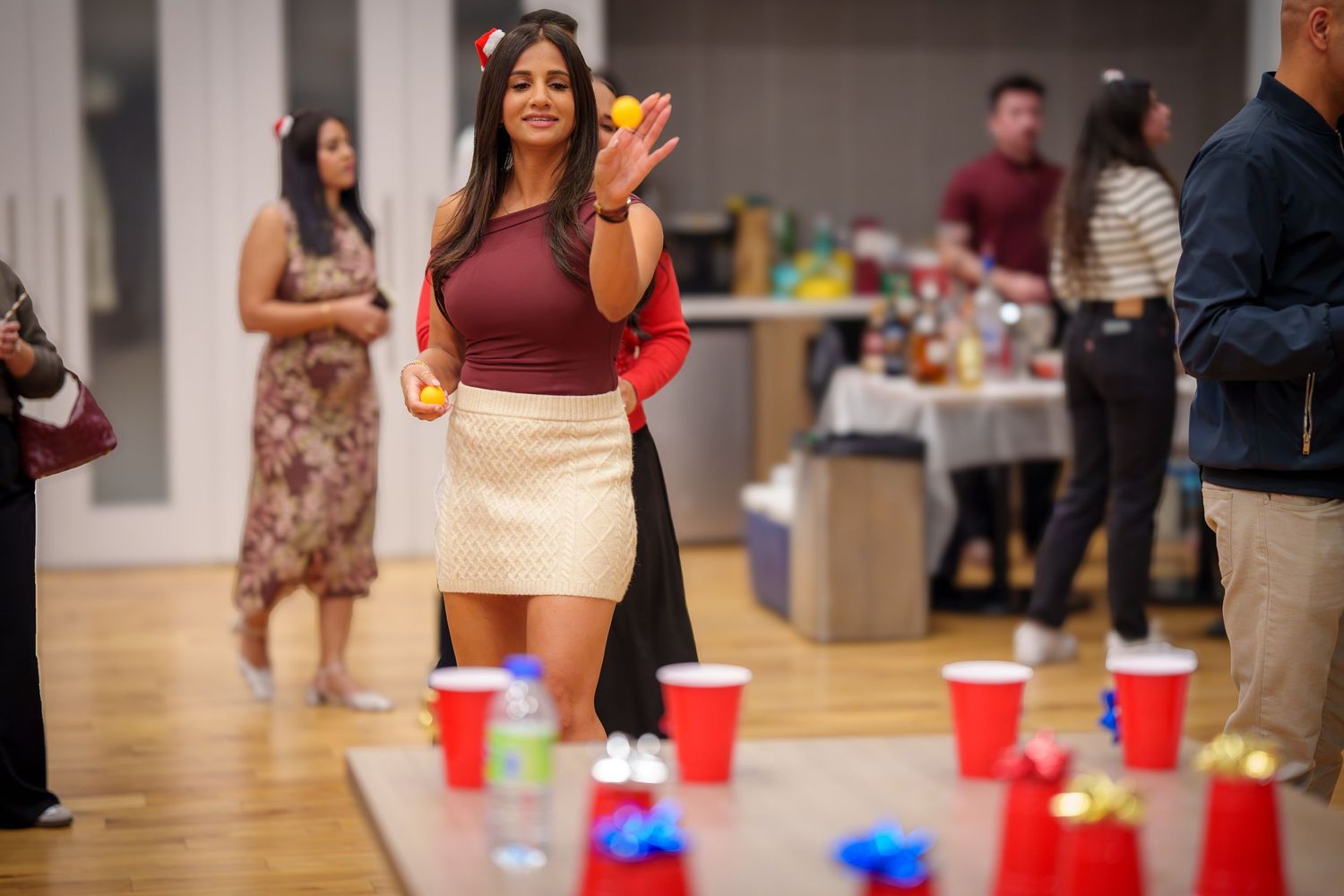 People standing near wall at social event with red cups in foreground.