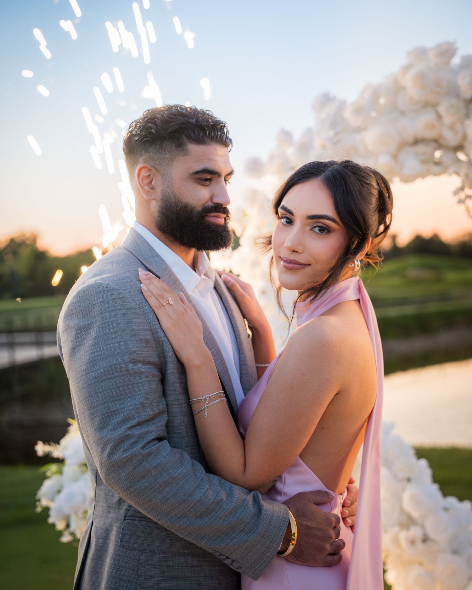 Romantic sunset photoshoot of a couple by a lakeside.