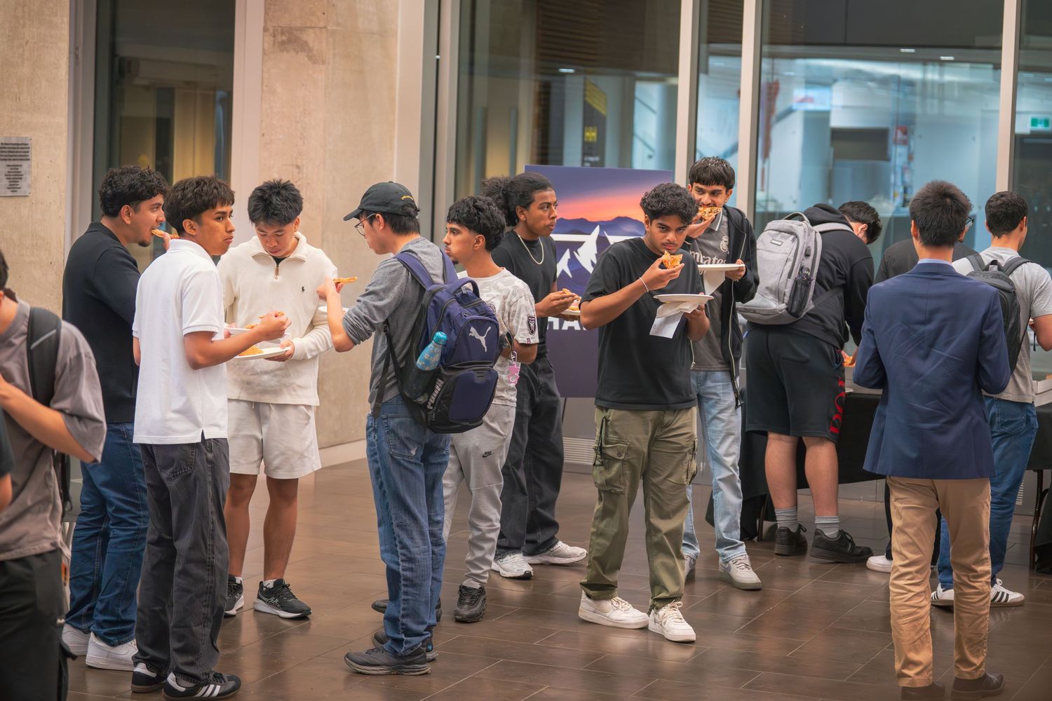 Group of people gathered outside a building entrance during a casual meetup.