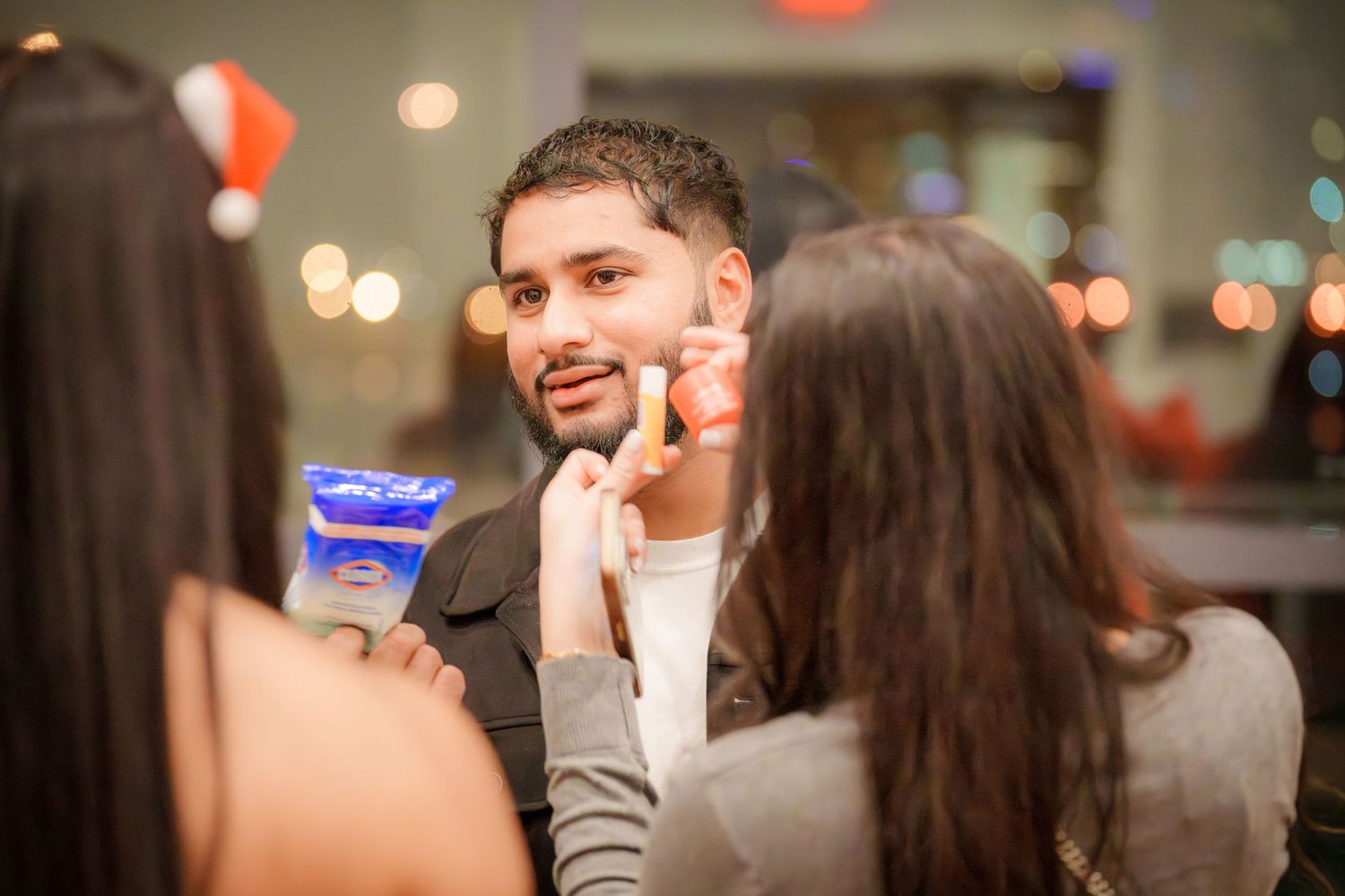Friends engaged in animated conversation during an evening party gathering.
