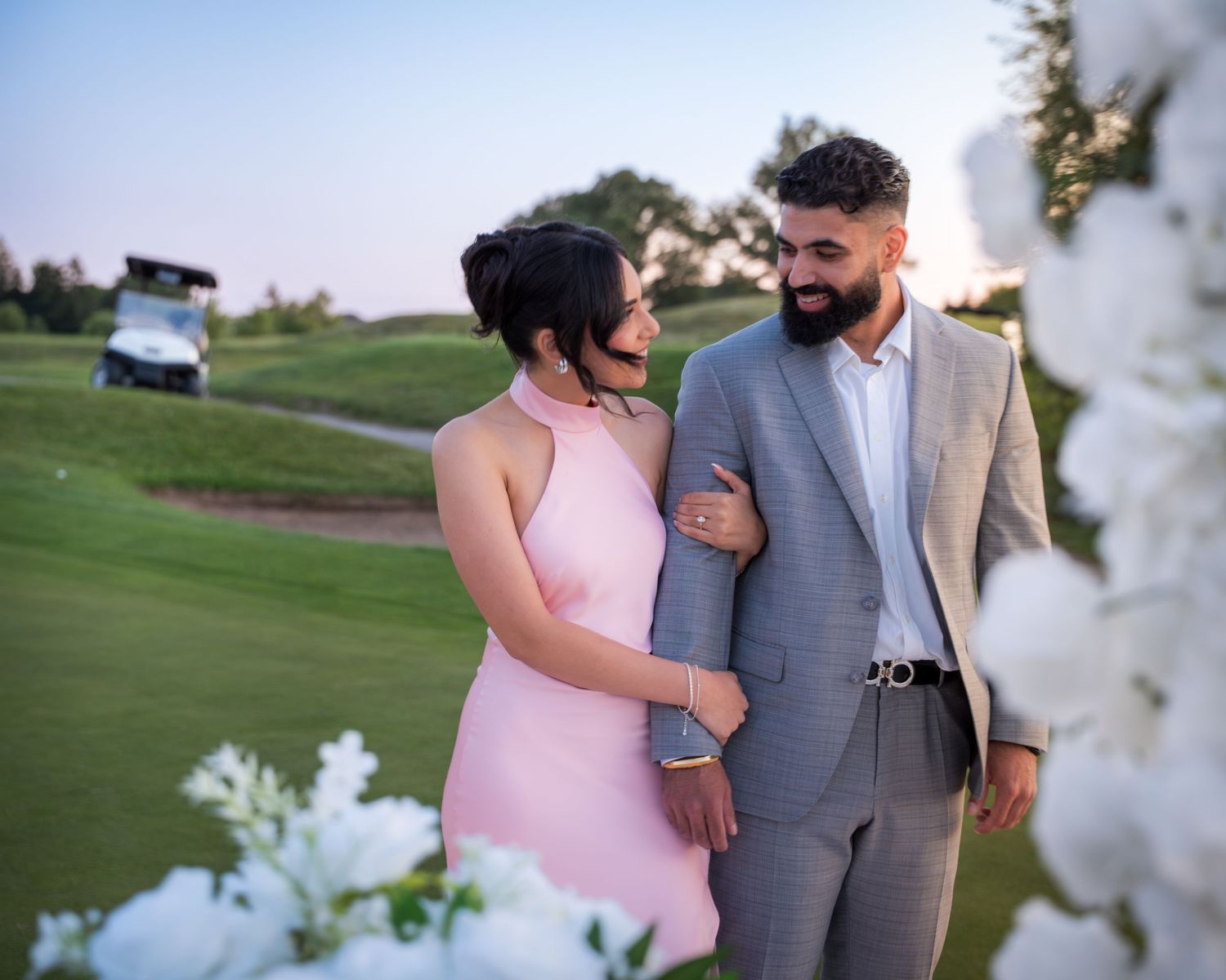 Candid moments captured between couple during outdoor sunset photoshoot.