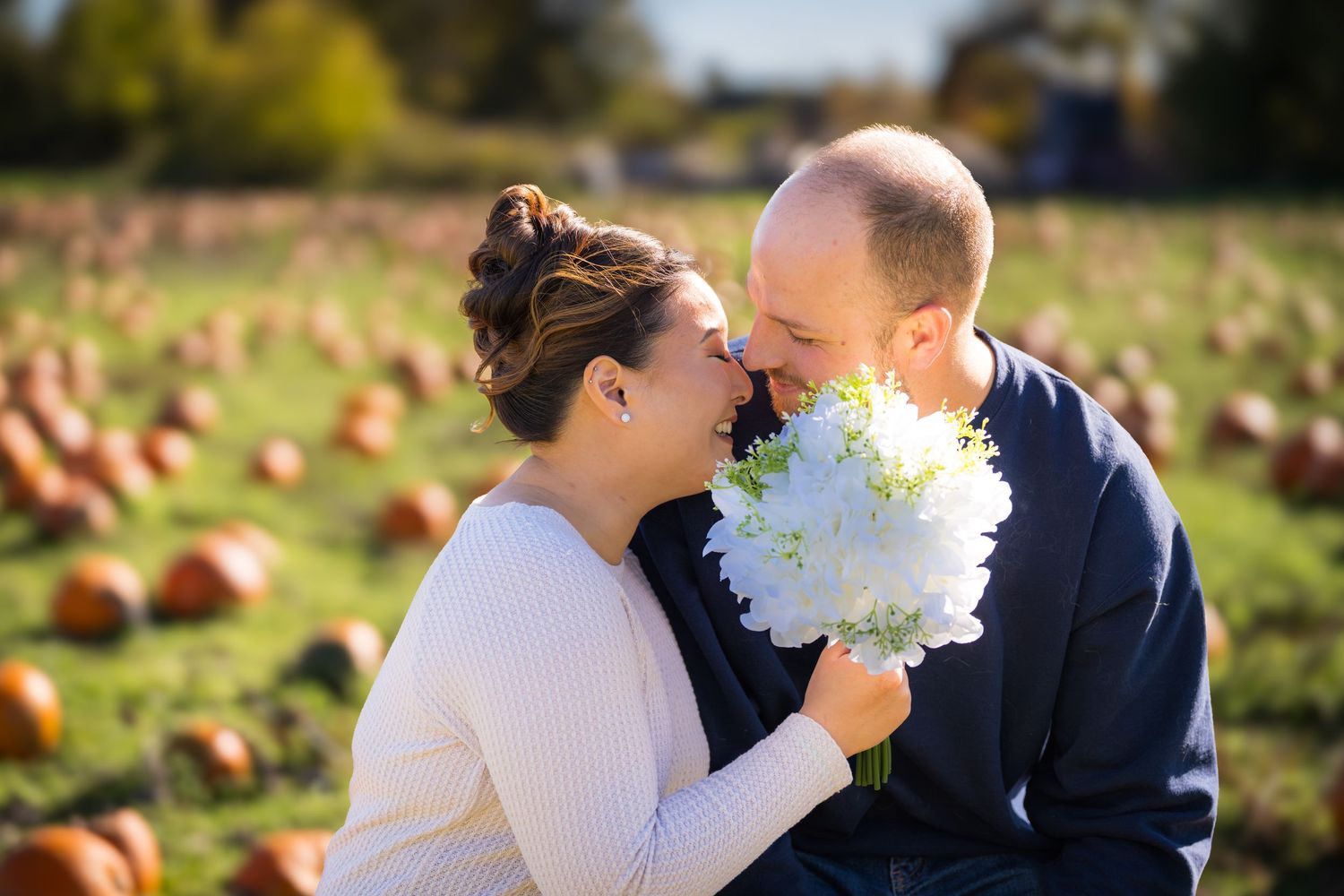 A series of romantic wedding photos taken at a pumpkin patch in autumn showing tender moments between newlyweds.