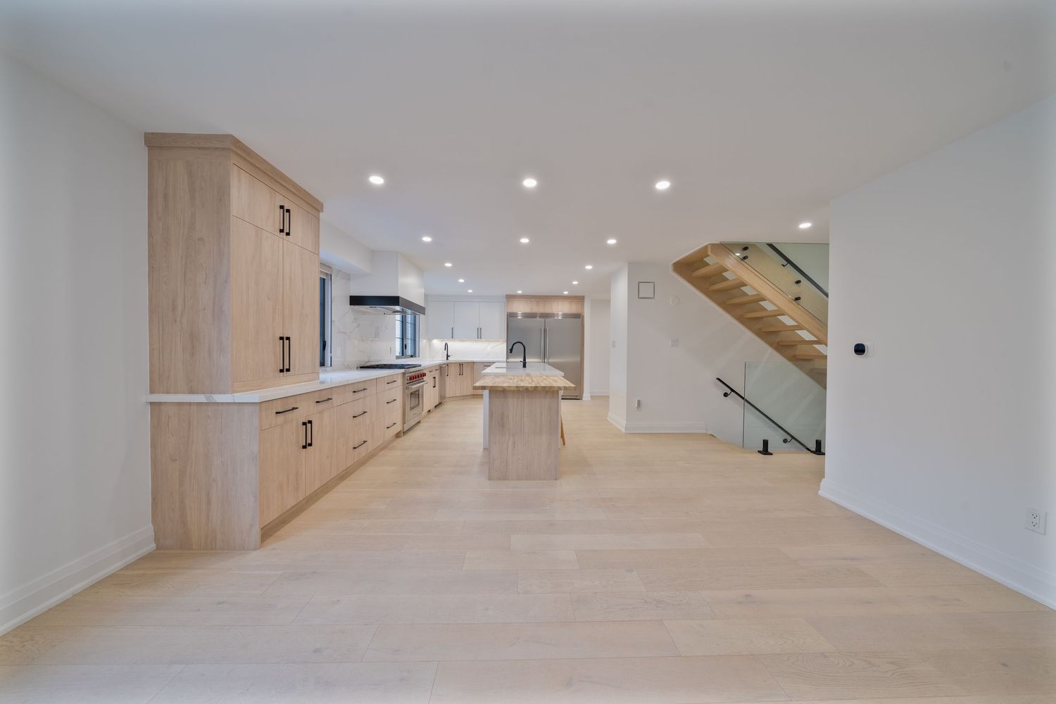 Modern white hallway with recessed lighting and numbered doors features clean lines and minimalist design elements.