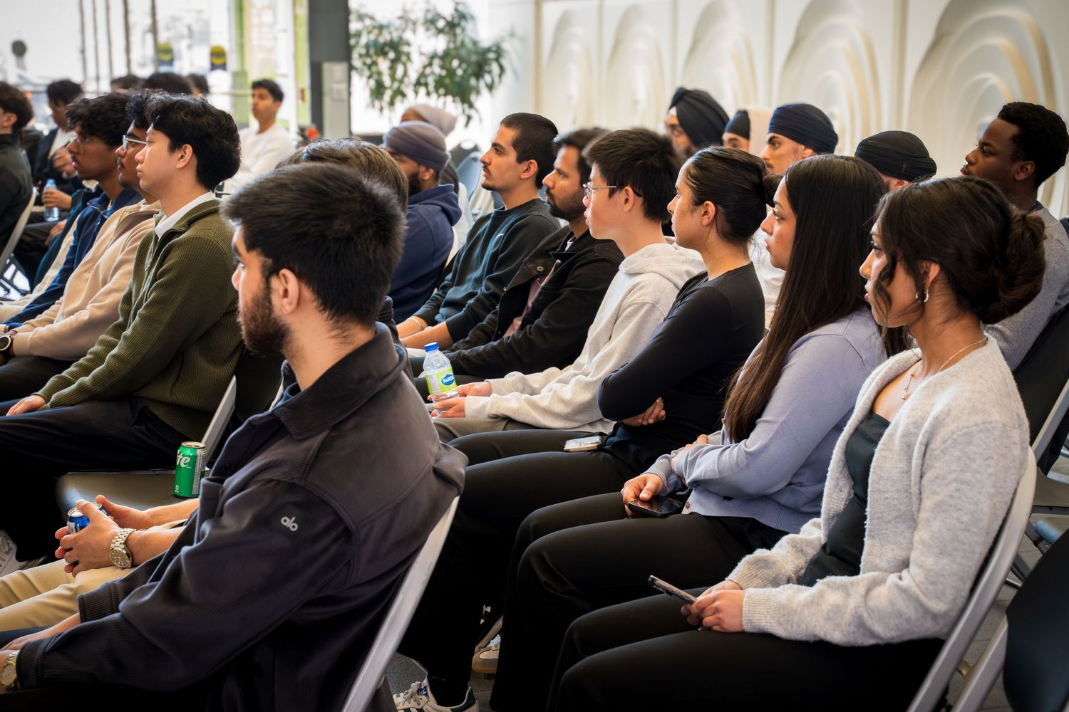 Professional conference audience watching intently during a business presentation.