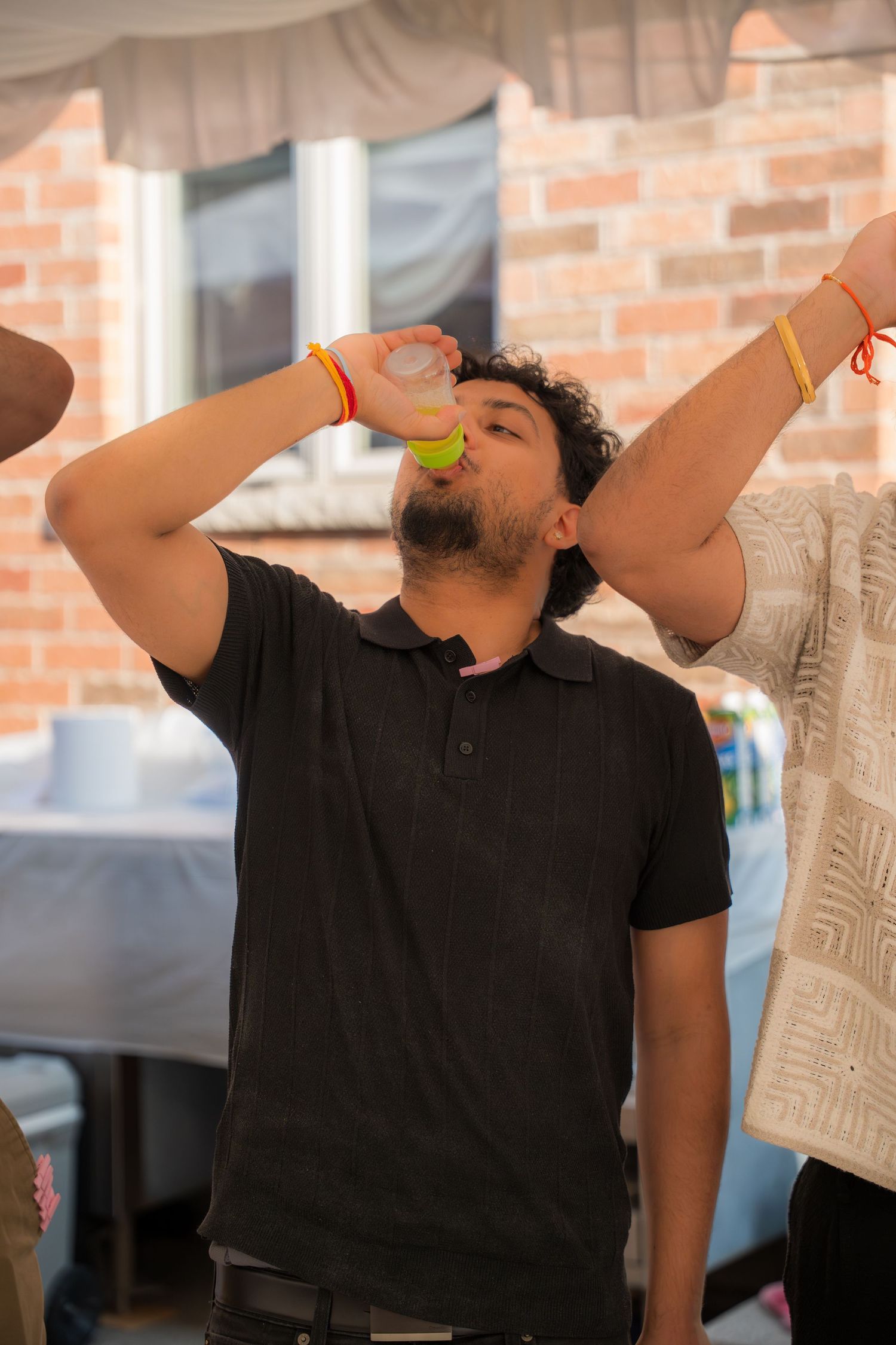 Group drinking shots in synchronization at indoor party venue.