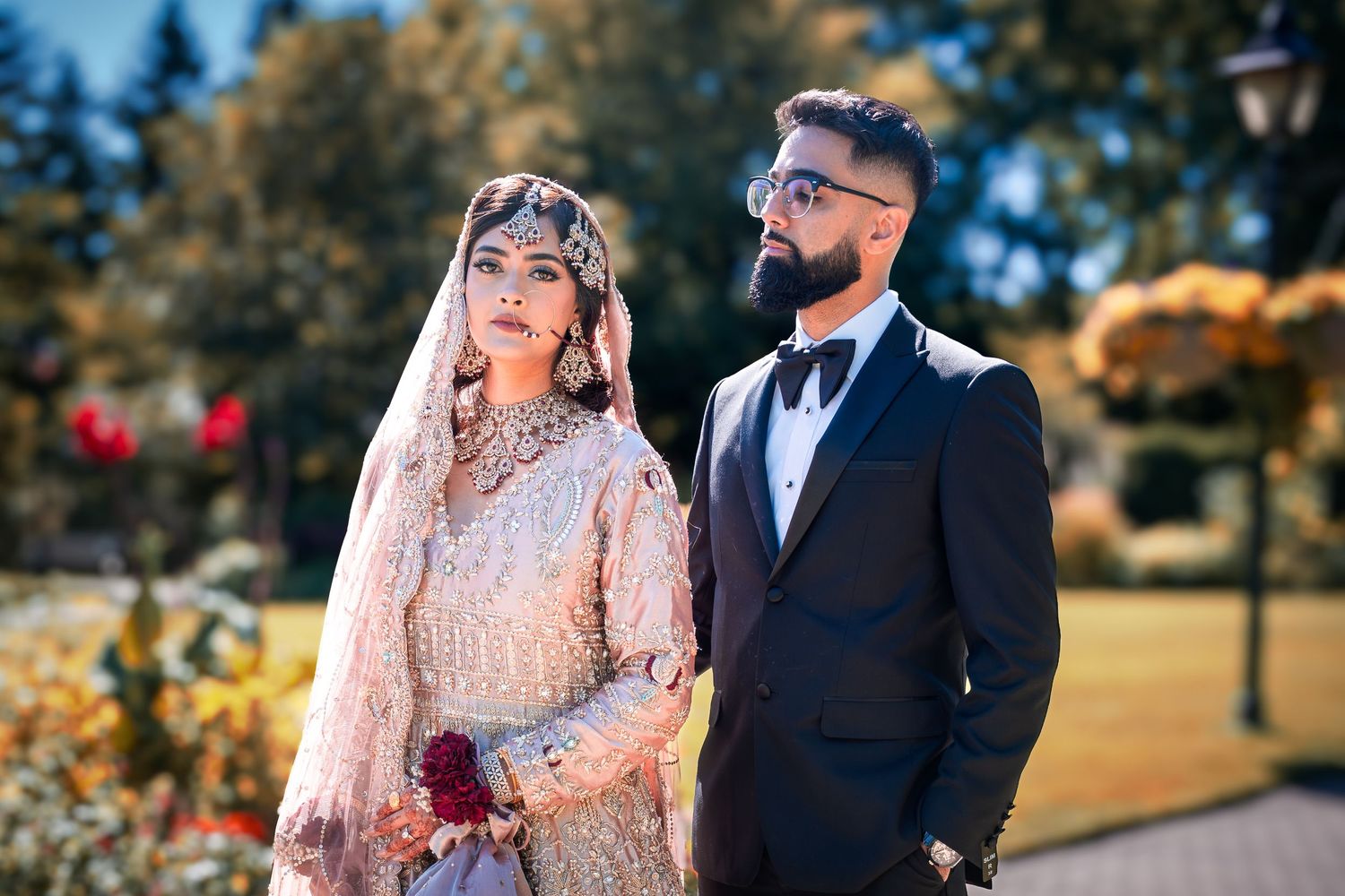 Romantic outdoor wedding photography session featuring ornate traditional South Asian attire.