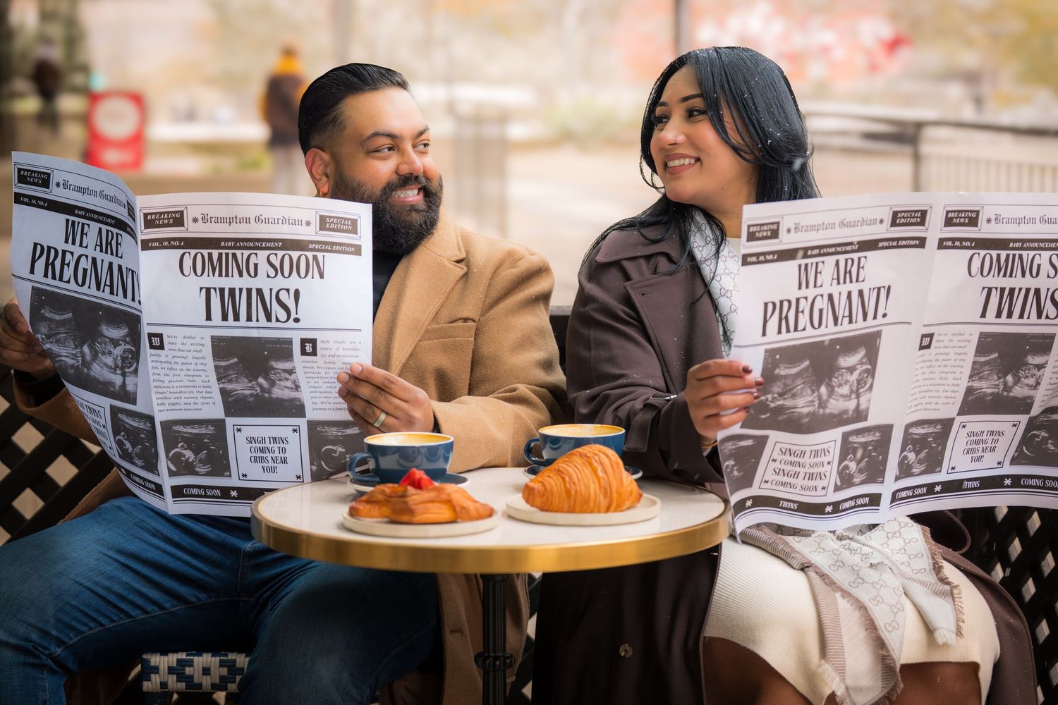 Diners at a cafe table reading newspapers while enjoying coffee and pastries.