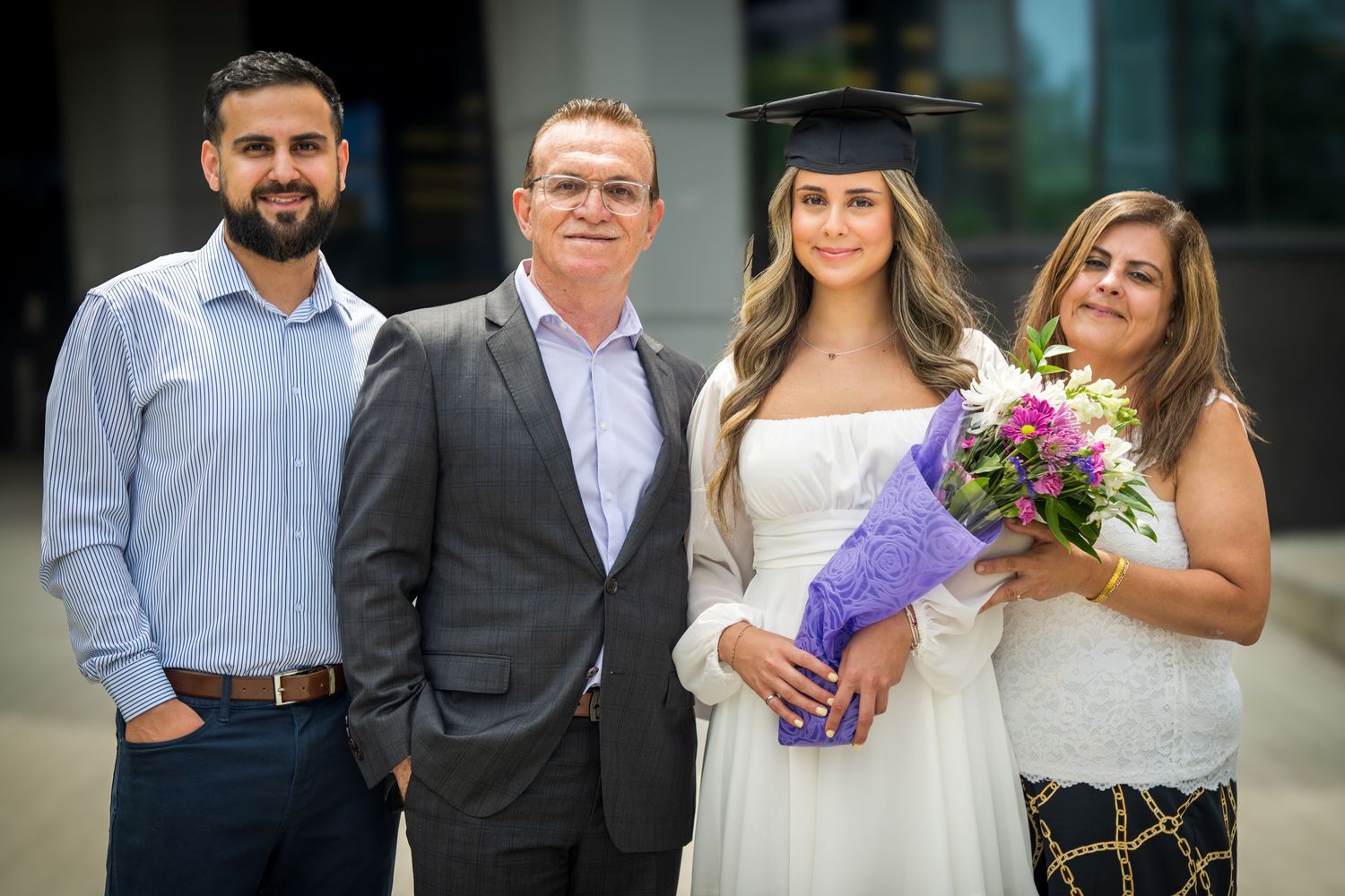 Group portrait showing mix of formal and casual attire at graduation event.