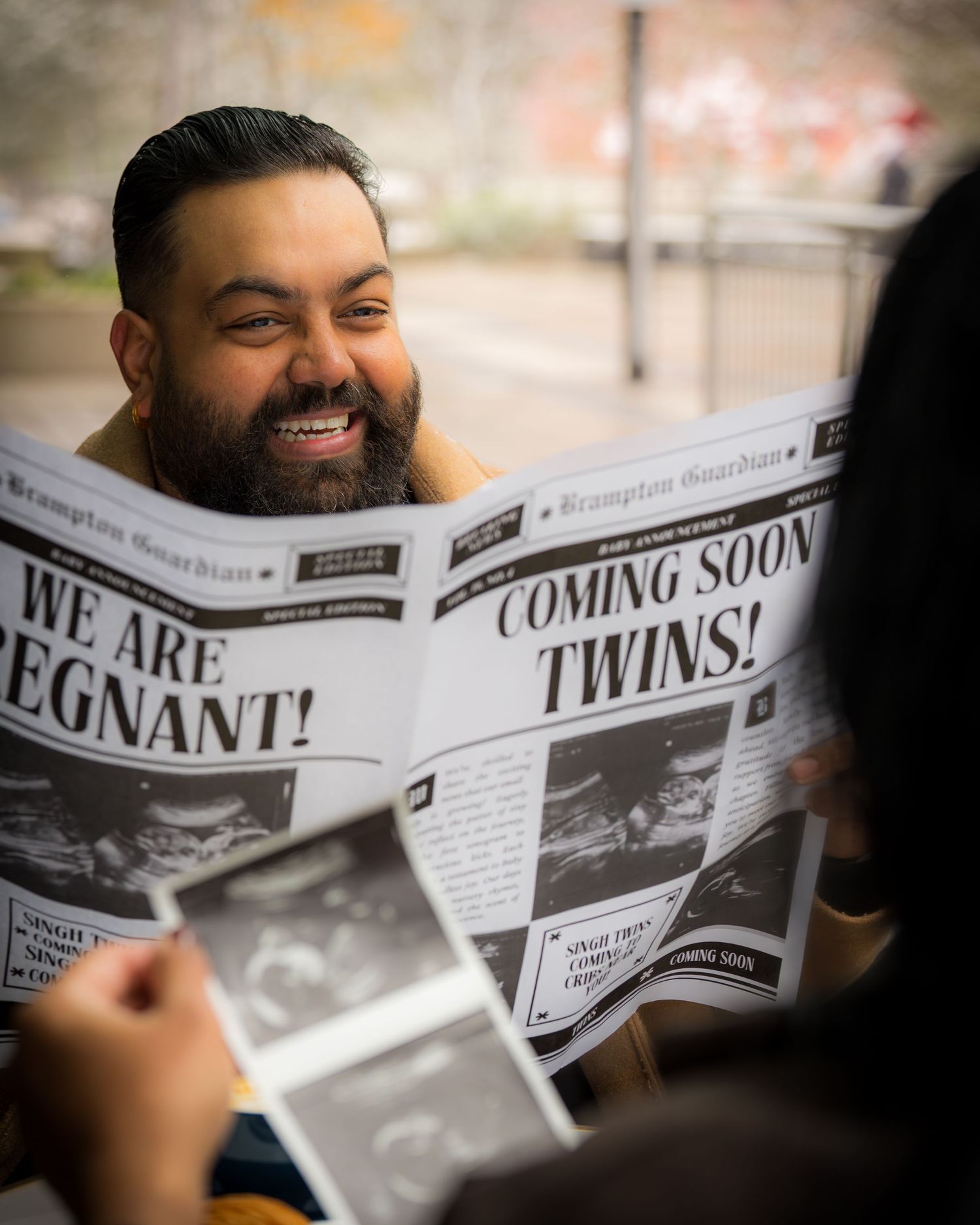 Close-up sequence of newspaper headlines revealing pregnancy announcement for twins.