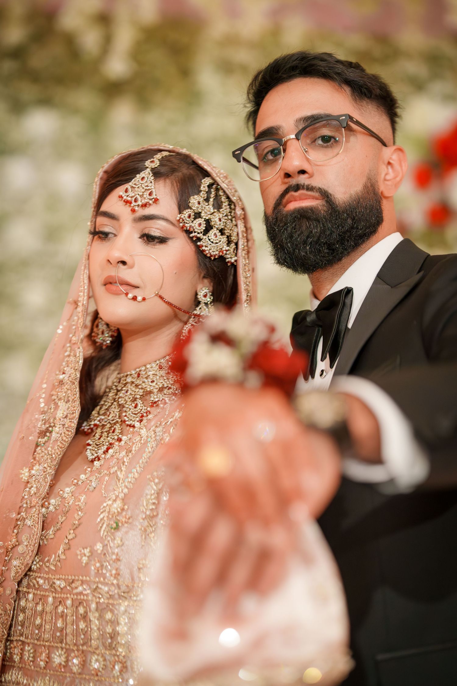 Intimate wedding portrait showing couple in traditional South Asian formal attire.
