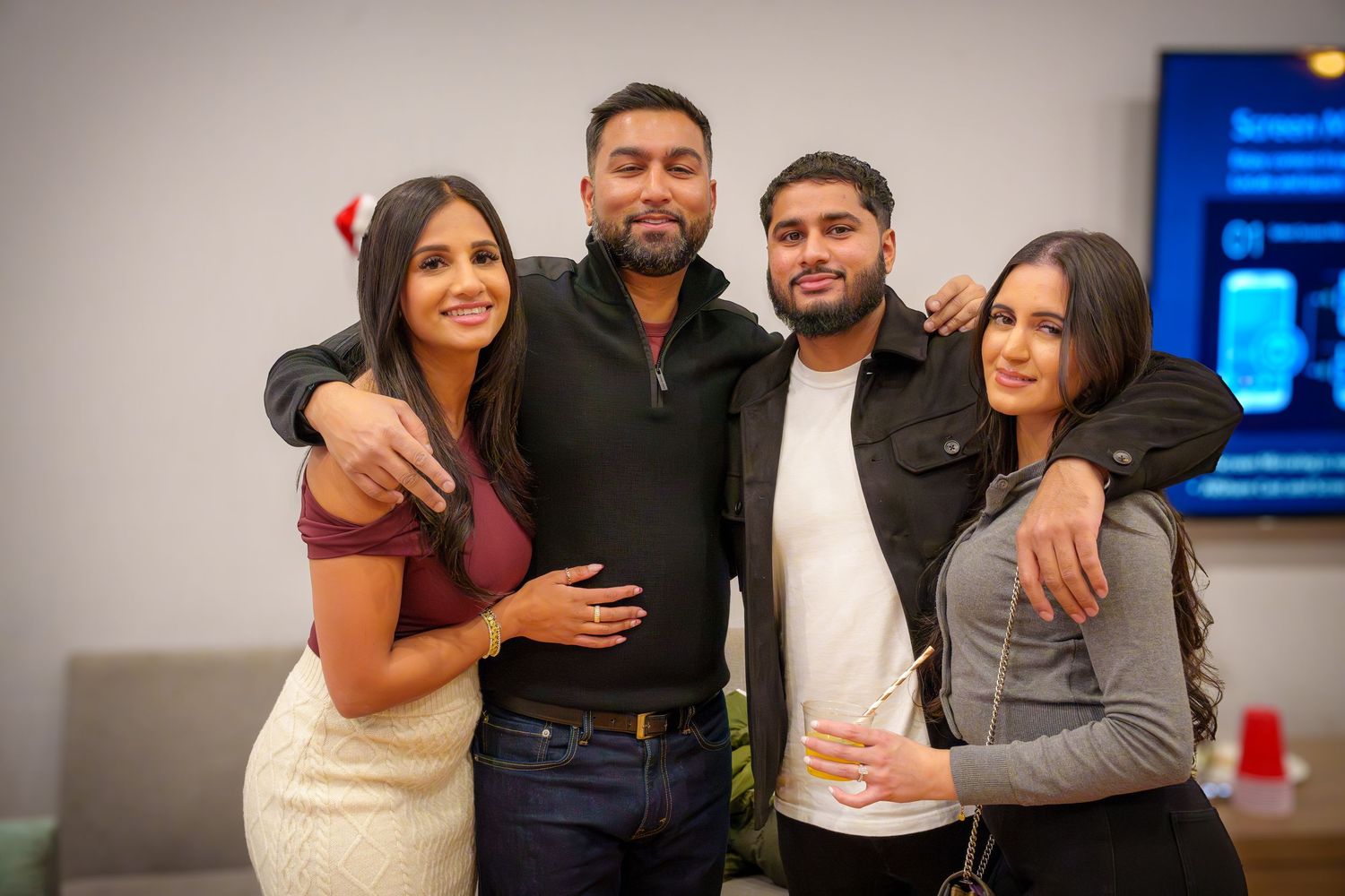Friends posing together for photos at an indoor celebration.