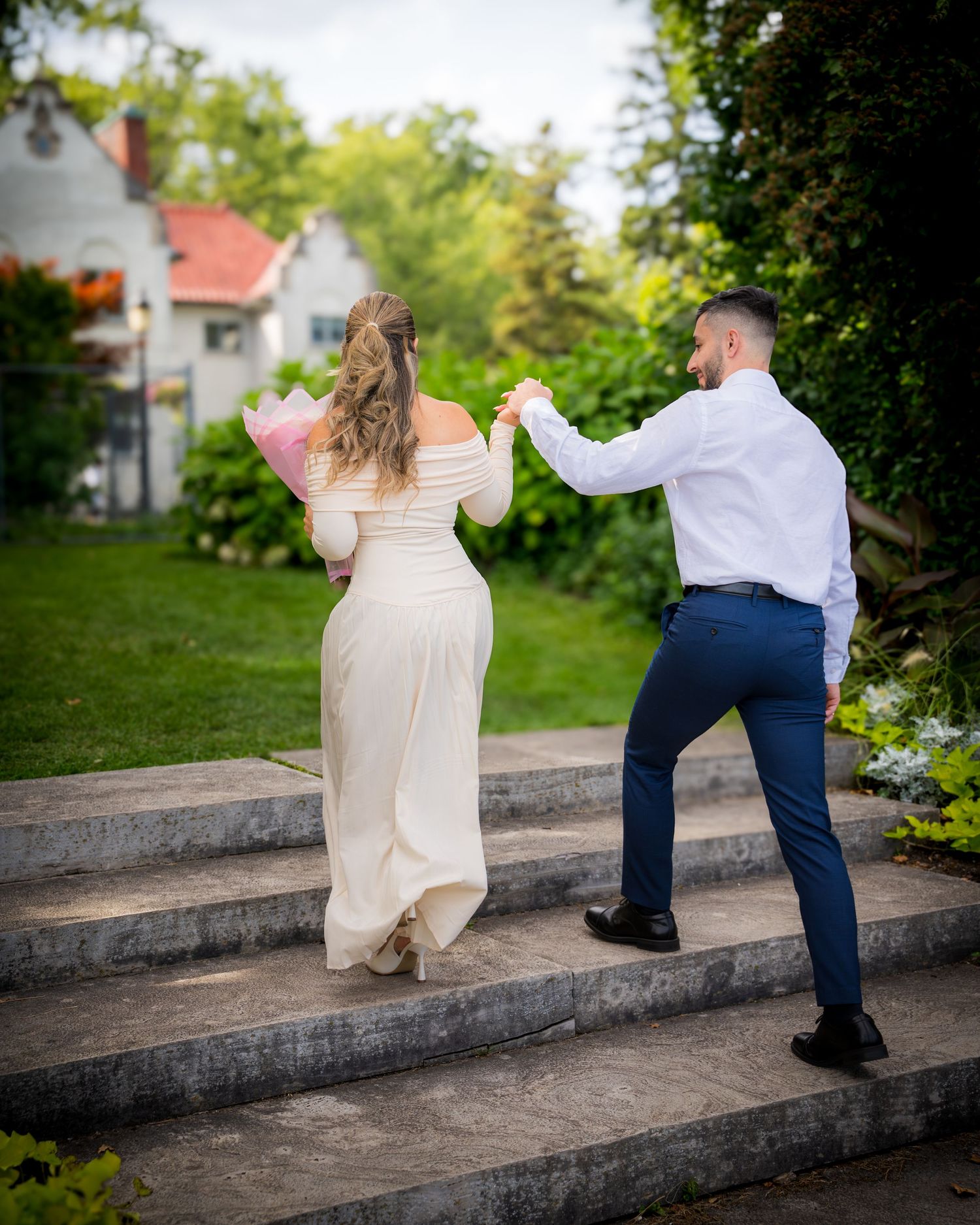 Couple playfully posing on concrete steps during outdoor photoshoot.