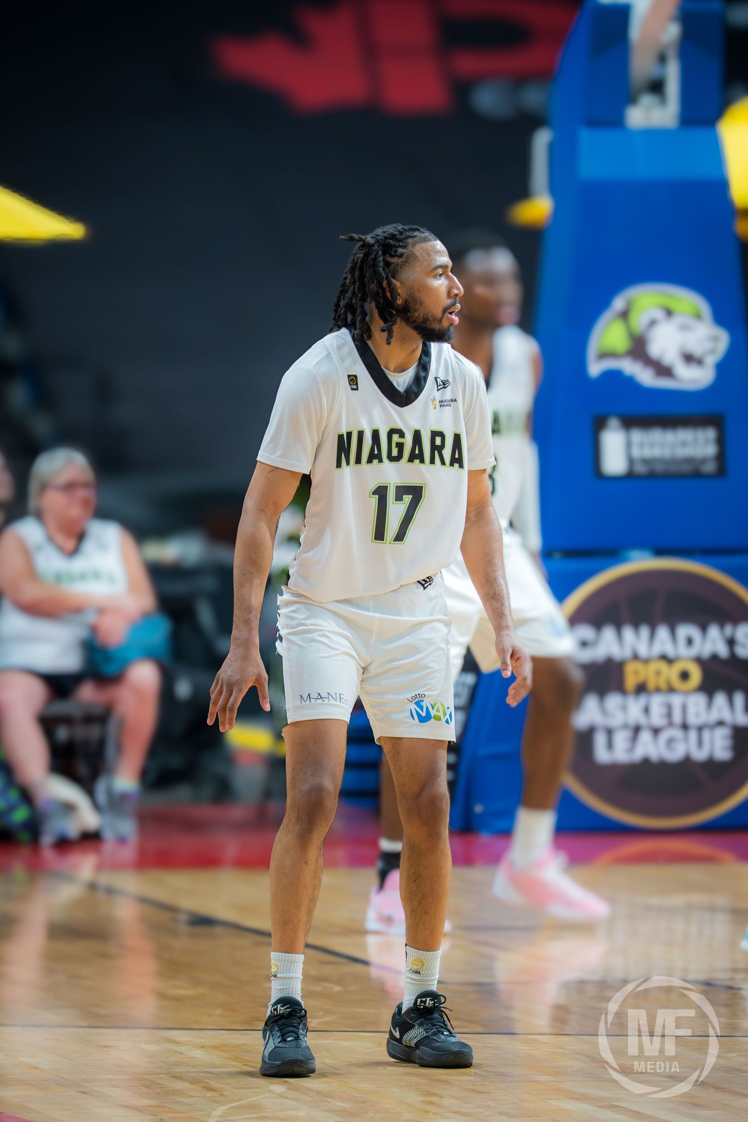 Niagara River Lions player number 17 with dreadlocks stands on court during Canada's Pro Basketball League game.
