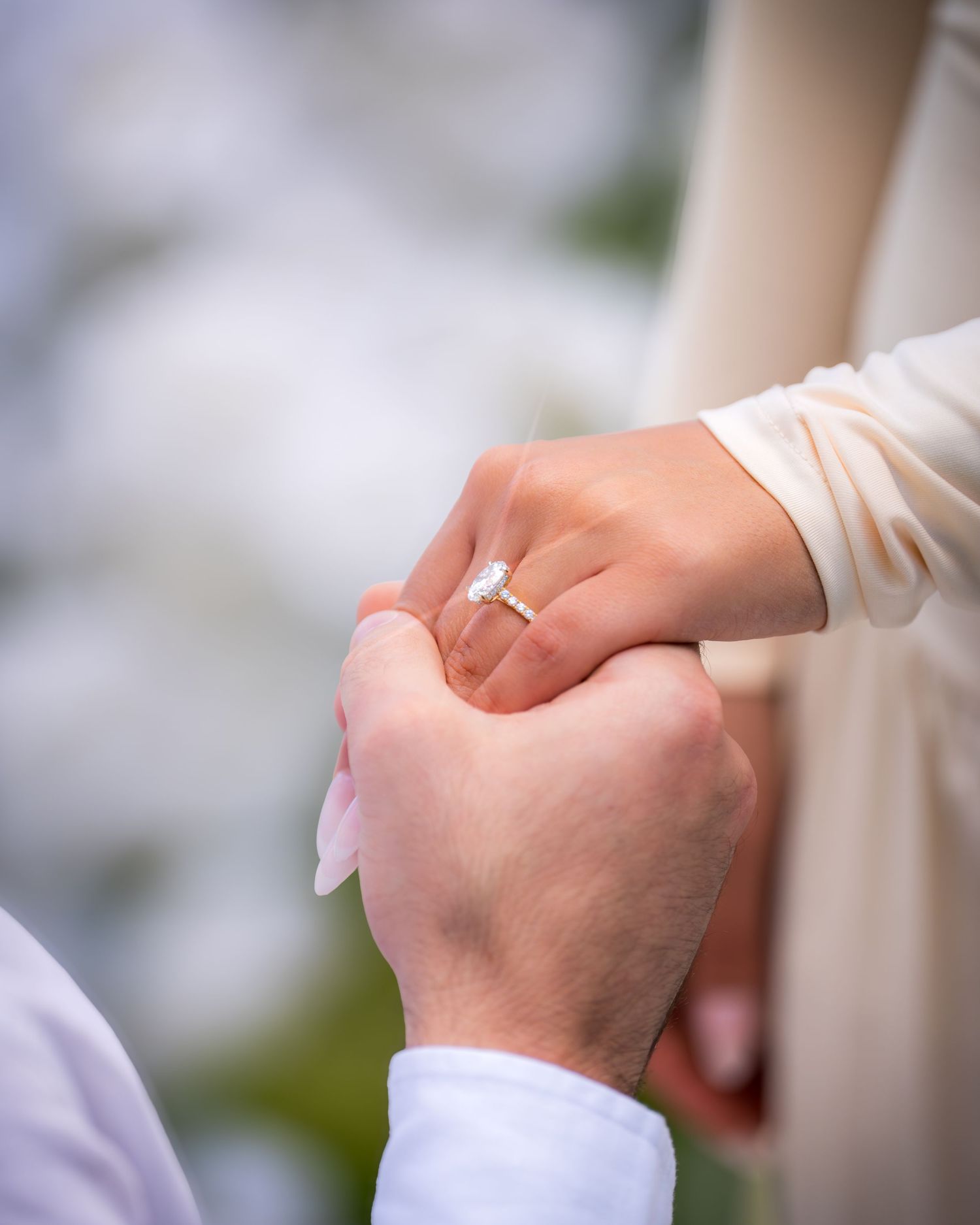 Close-up shot of hands during a proposal moment with an engagement ring.