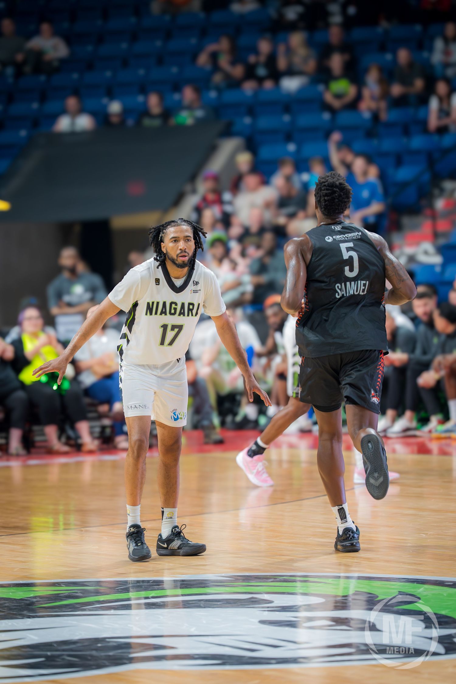 Niagara River Lions player #17 guards opponent #5 Samuel during a CEBL basketball game.