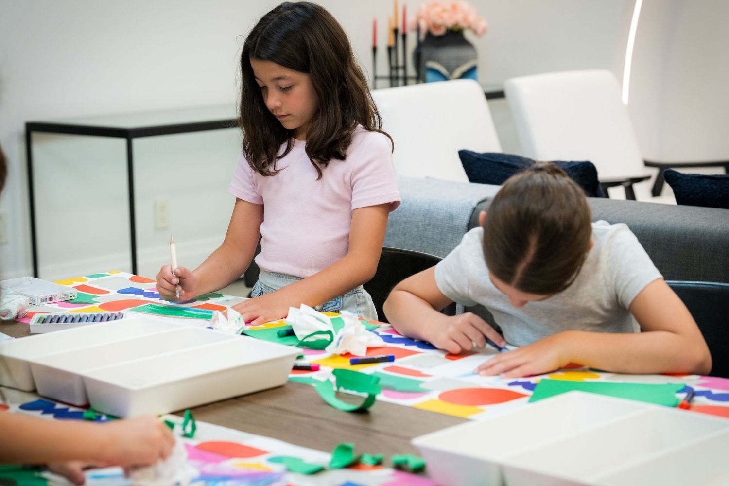 Children work on vibrant paper collage and painting projects during an art workshop.