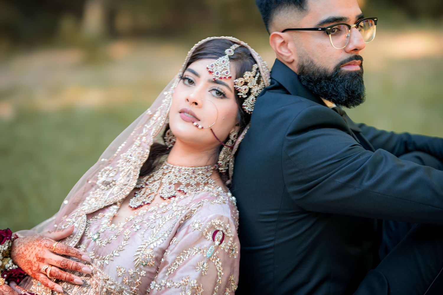 Elegant wedding portraits captured in a lush garden setting with natural lighting.
