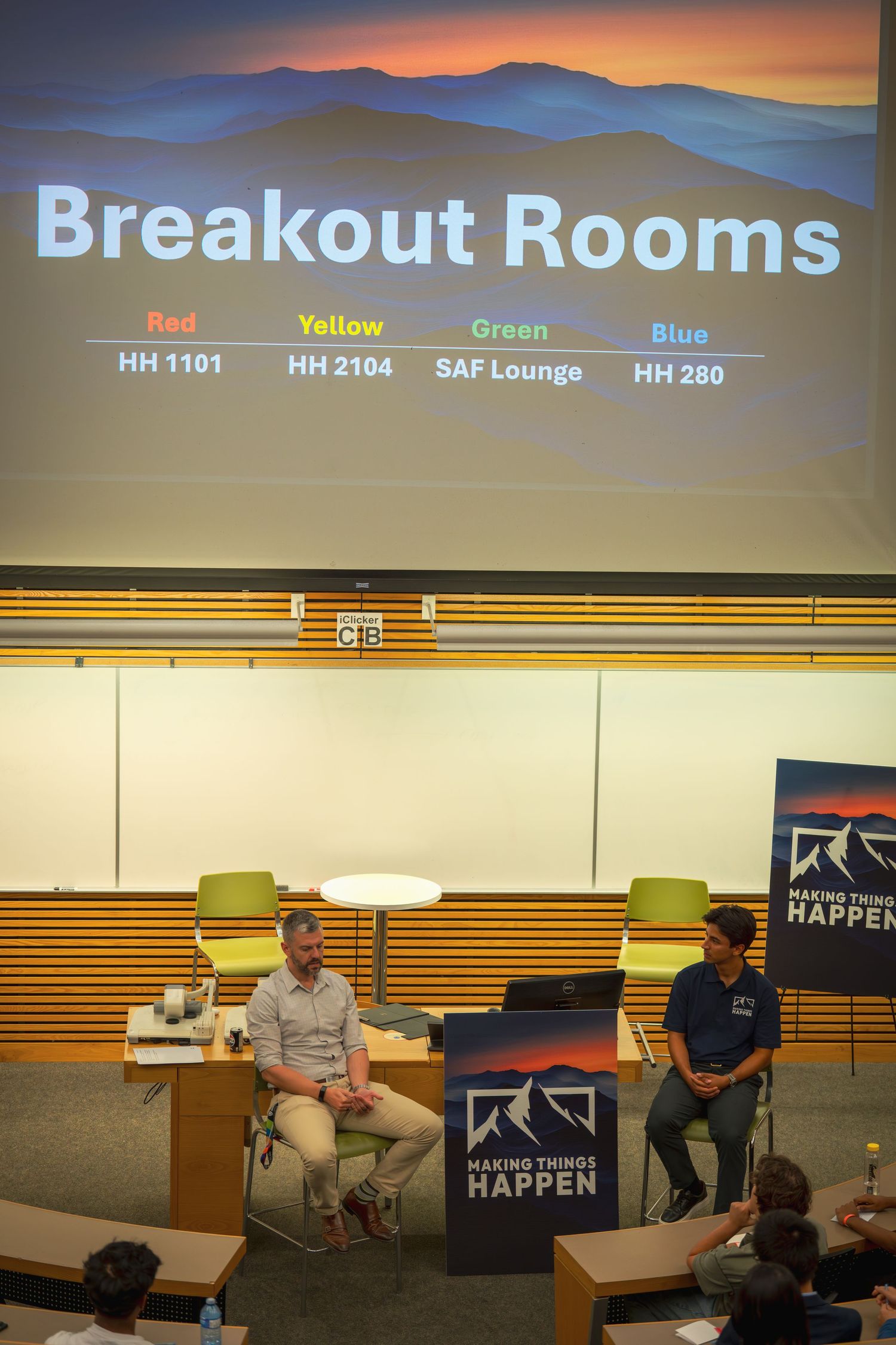 A presentation slide showing breakout room locations displayed in a modern conference space.