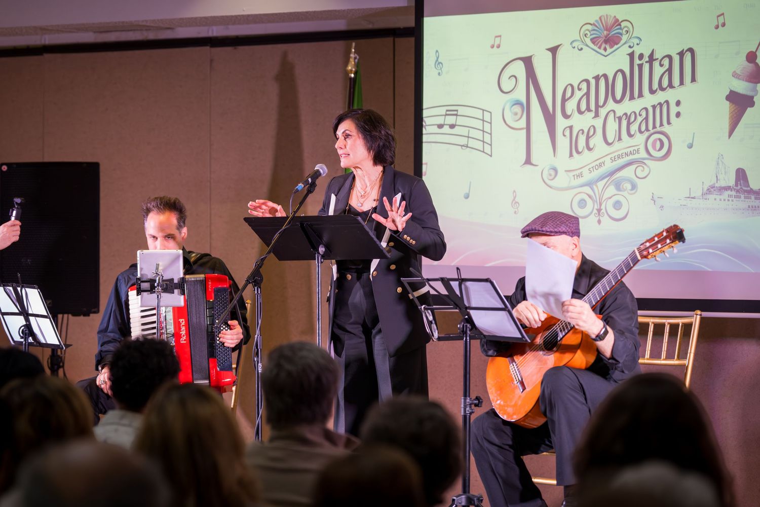 Female vocalist performs at Neapolitan Ice Cream themed event with accordion and guitar accompaniment.