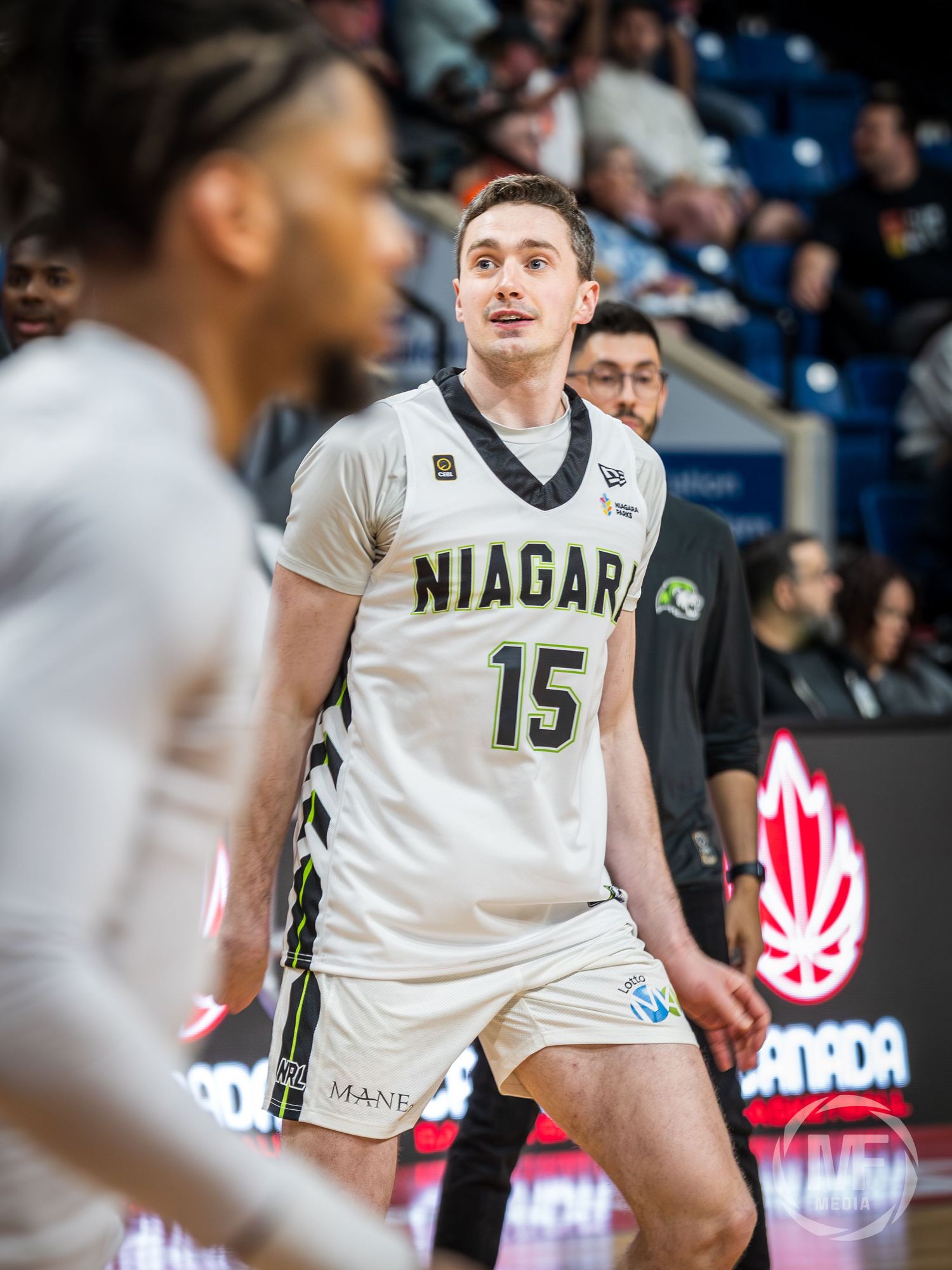 Niagara basketball player number 15 in white uniform on court during a professional game in Canada.