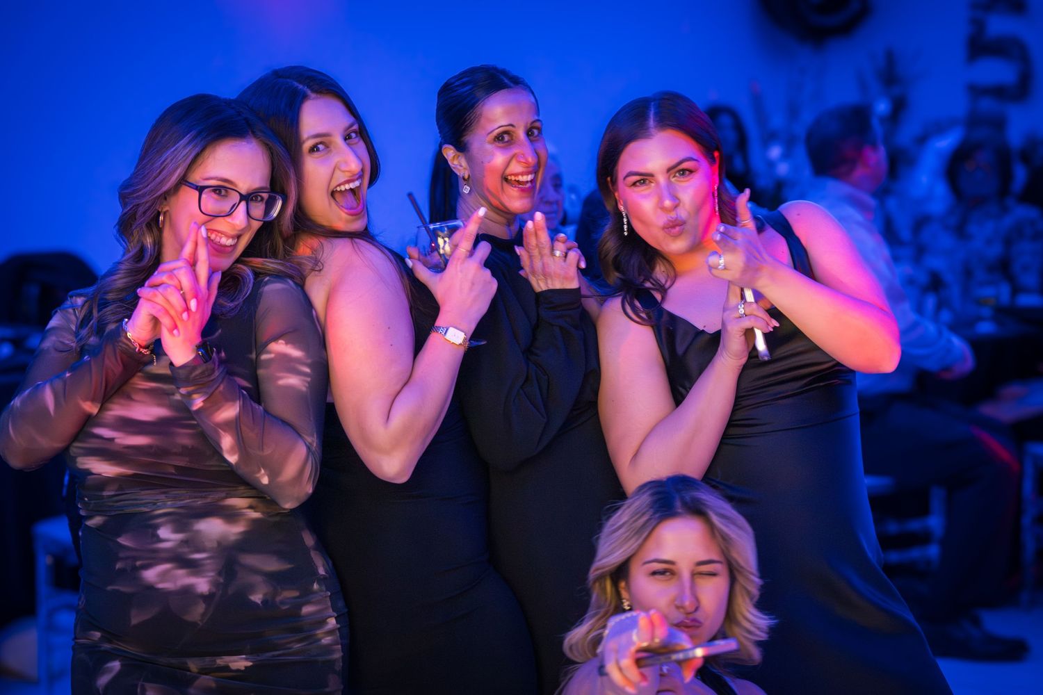 People enjoying themselves at a party with blue lighting effects.
