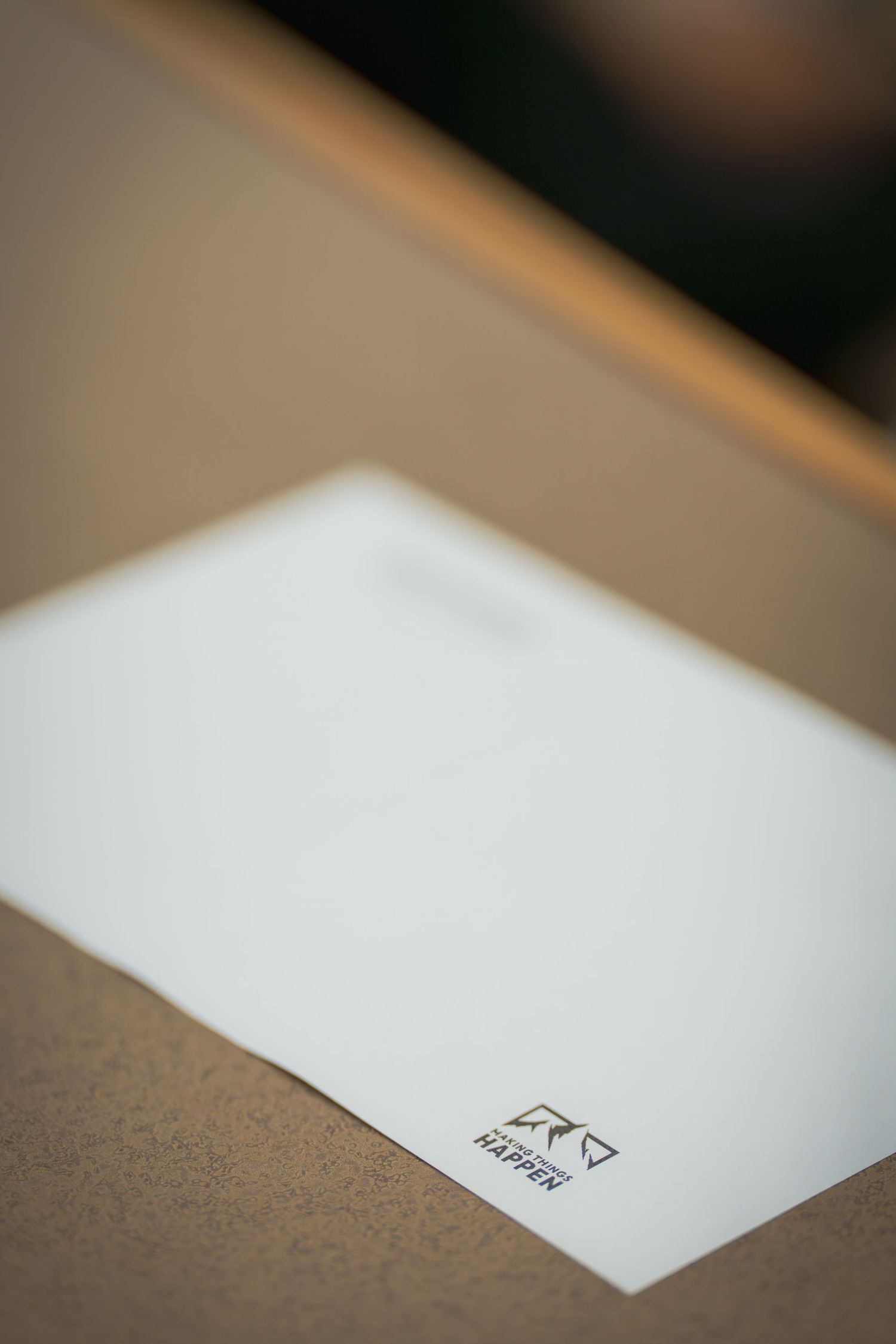 Close-up shot of white paper documents on a dark surface.