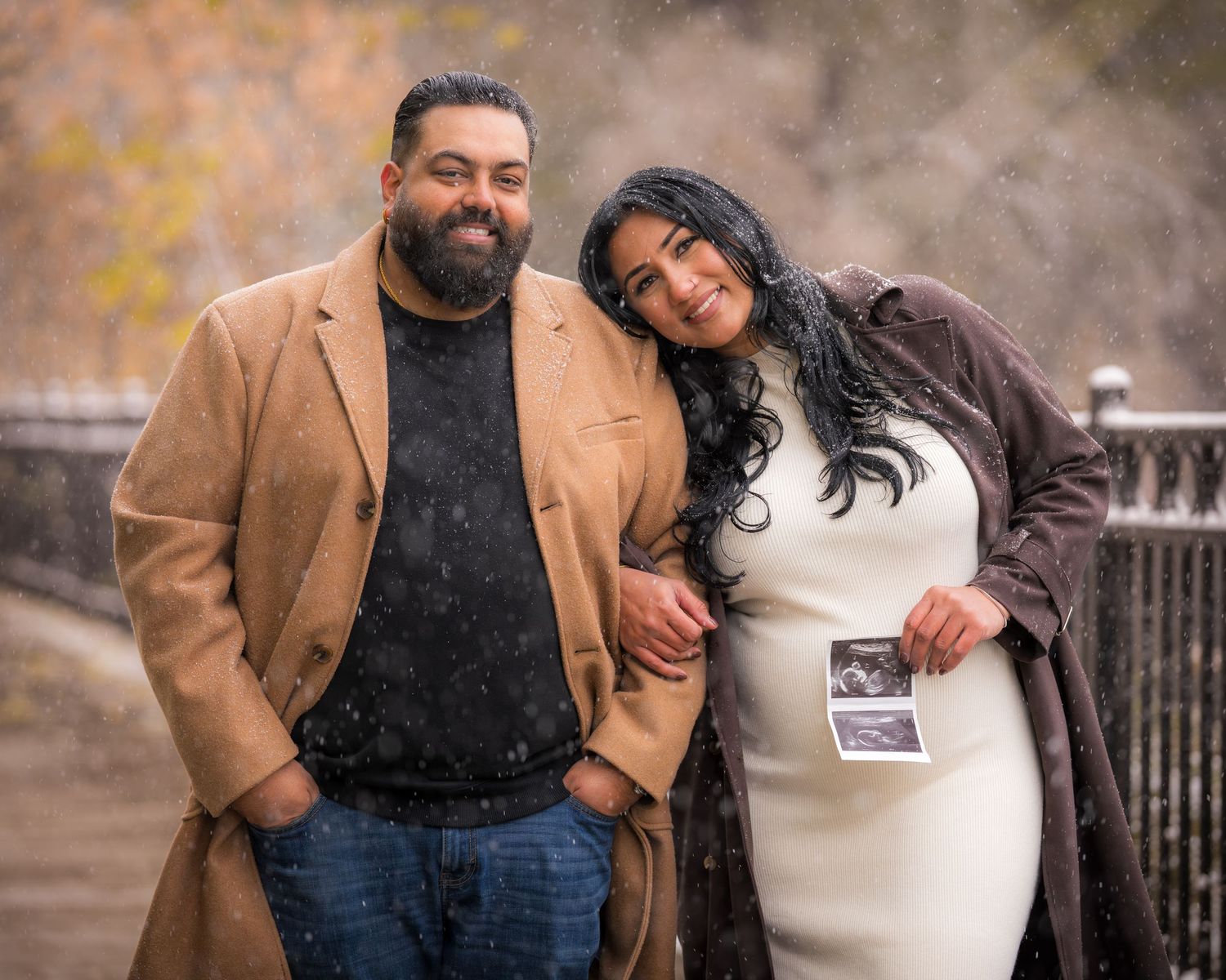 A couple shares a tender moment in winter clothing.