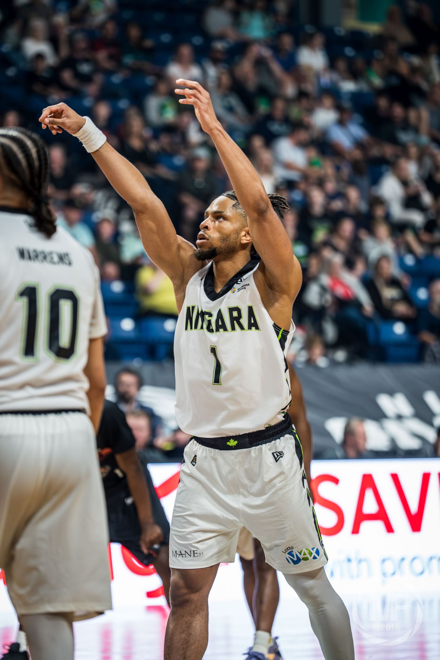Niagara River Lions player #1 follows through on a jump shot during a professional basketball game.