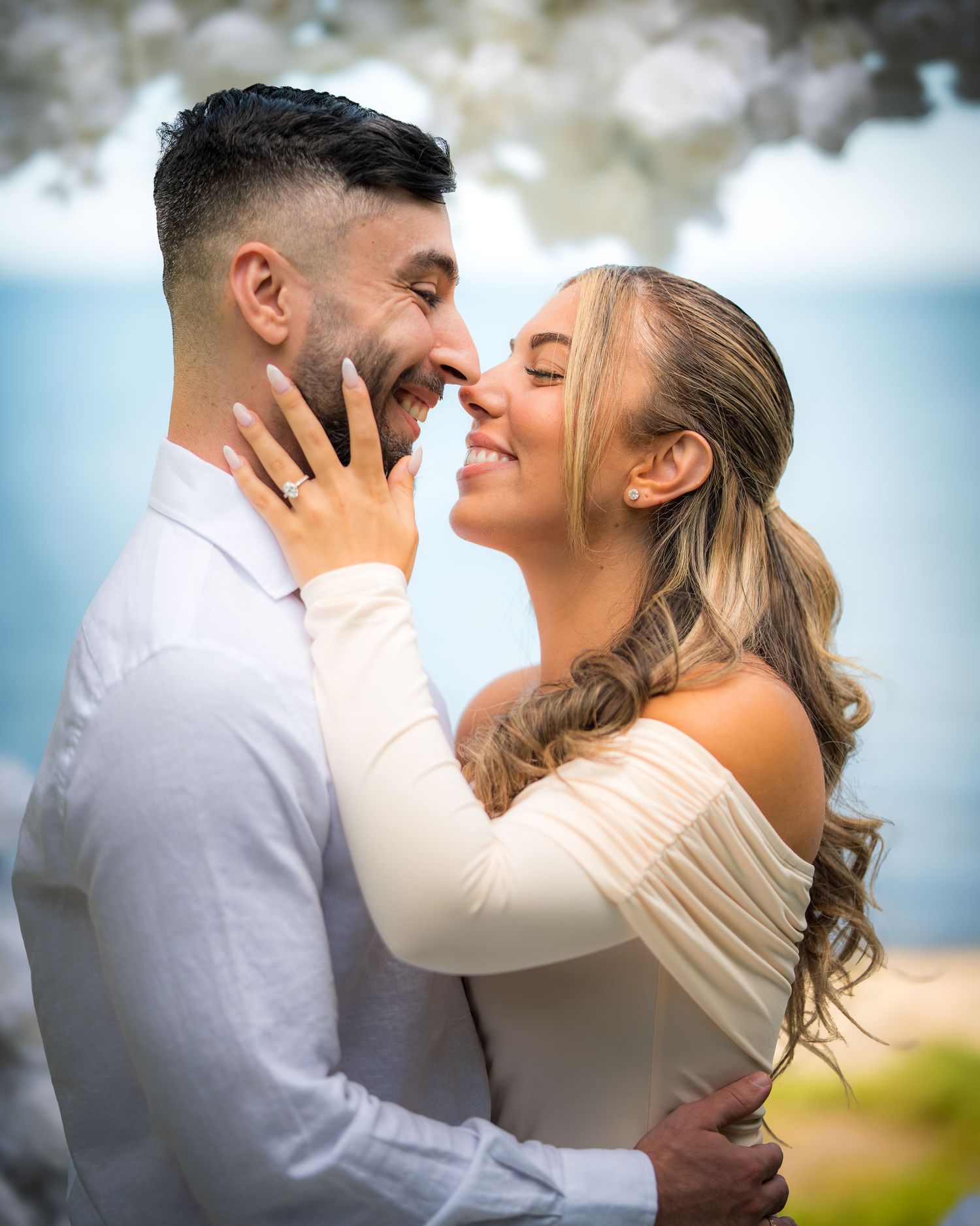Intimate moment between newlyweds sharing a romantic dance outdoors.