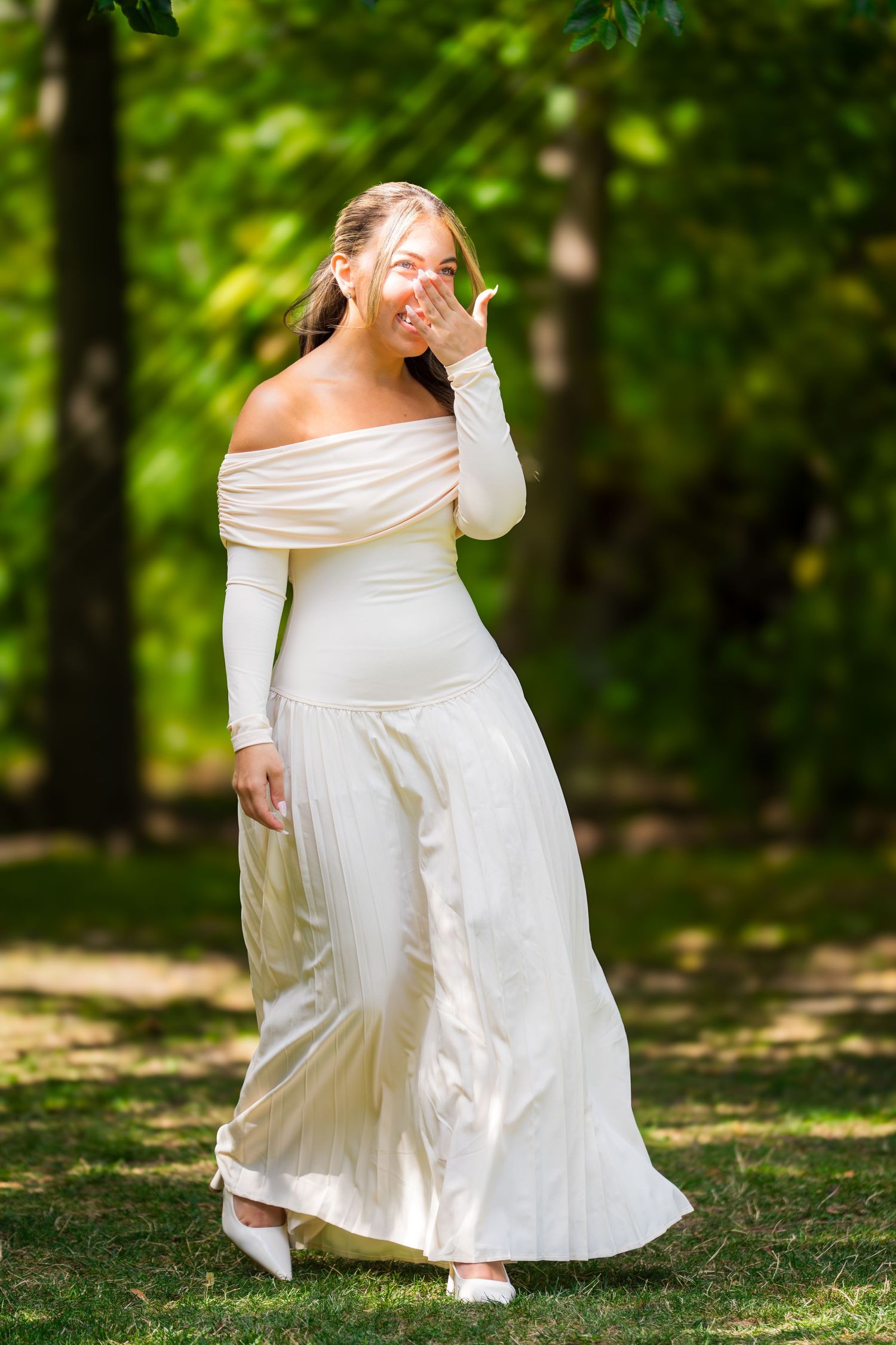 Elegant bridal portraits in a natural woodland setting with soft lighting.