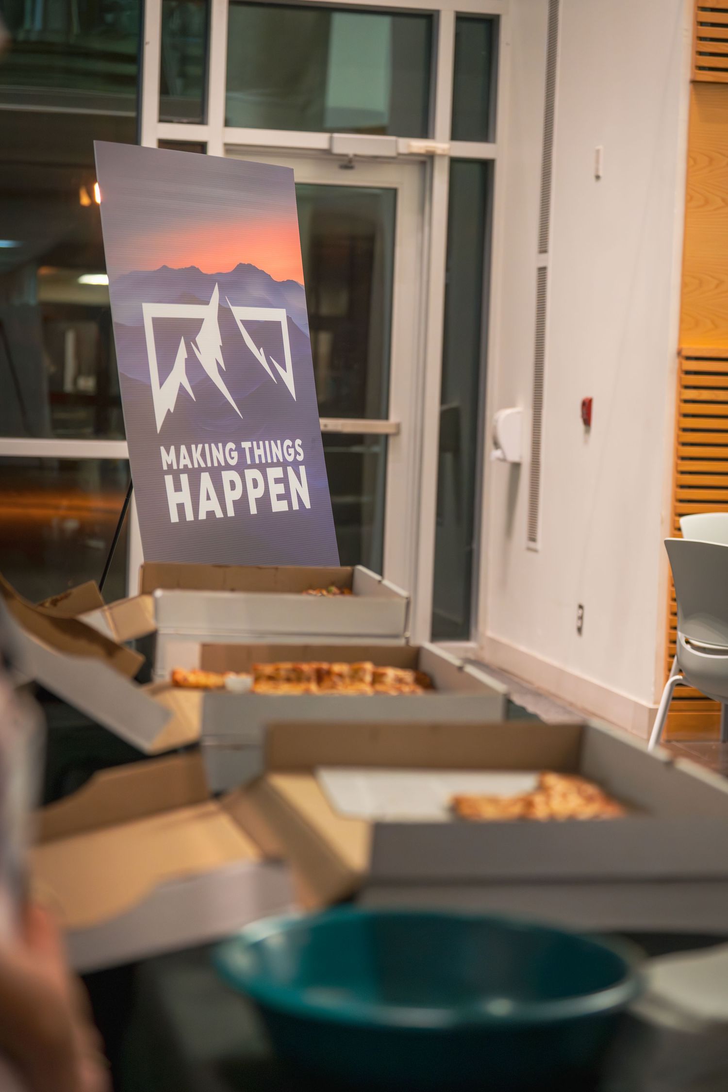 'Making Things Happen' signage displayed in a modern office setting.