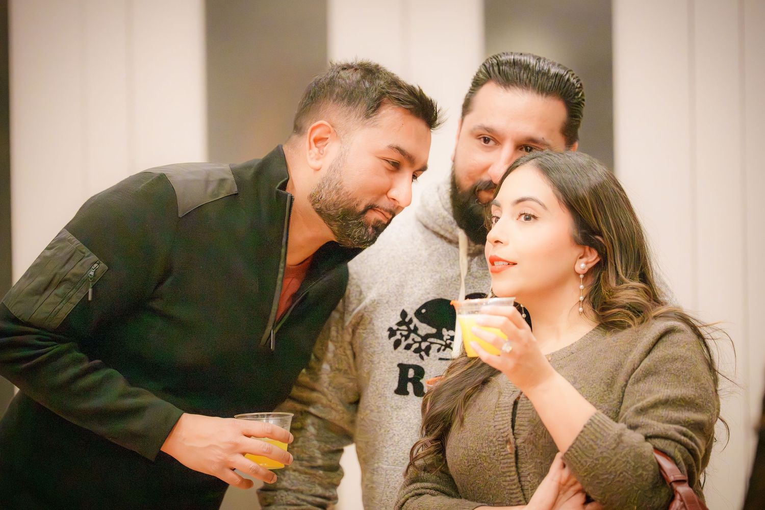 Indoor party scene with people socializing in casual attire.