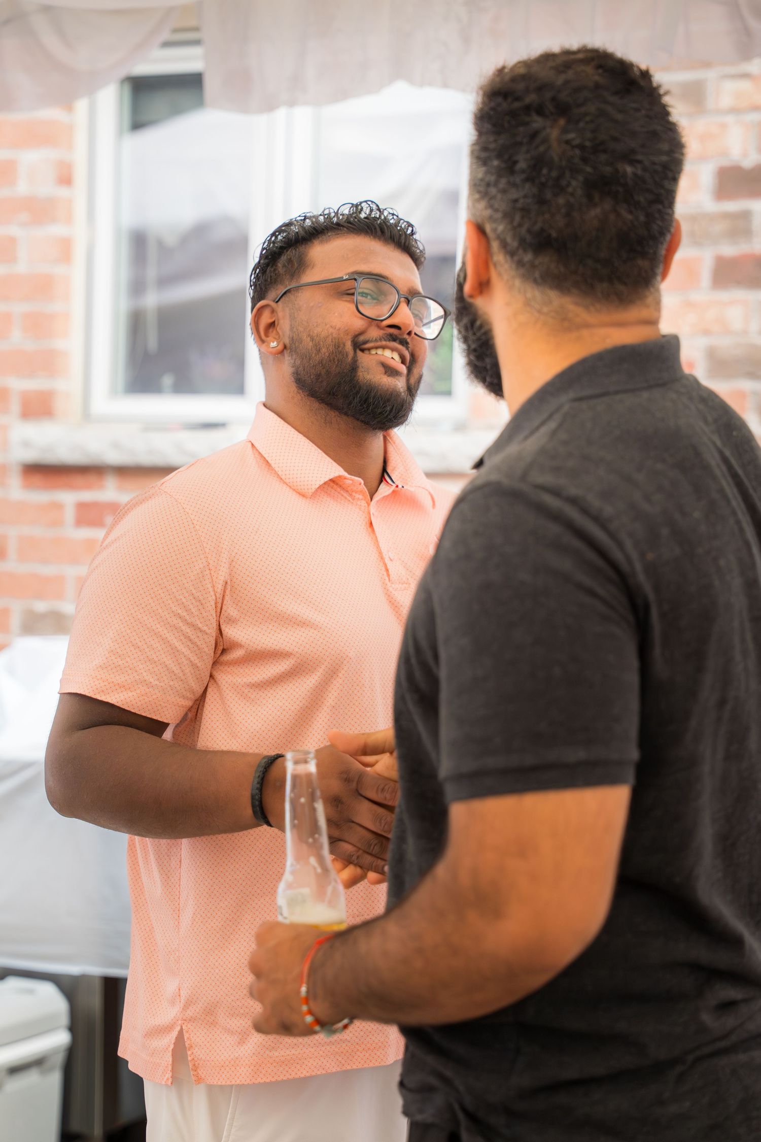 Party guests enjoying conversation and drinks at an indoor celebration.