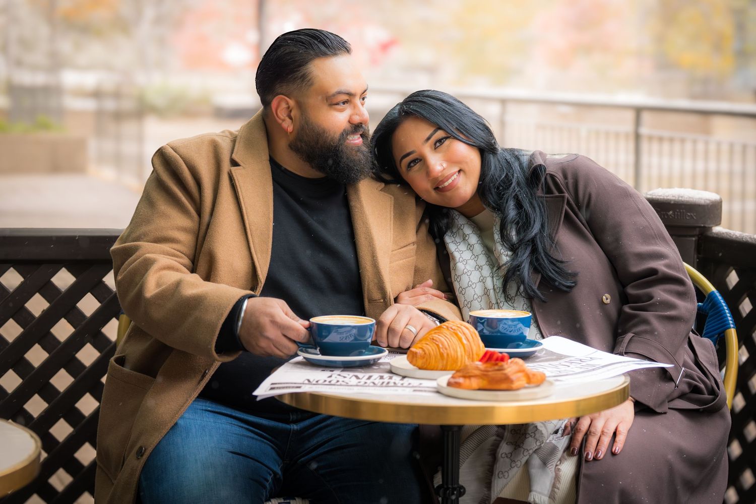 Couple sharing an intimate moment while dining at an outdoor restaurant.