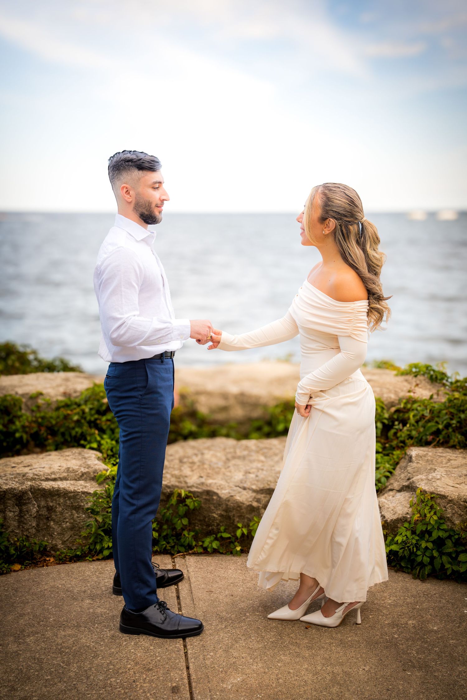 A romantic dance sequence captured on a coastal overlook with ocean views.