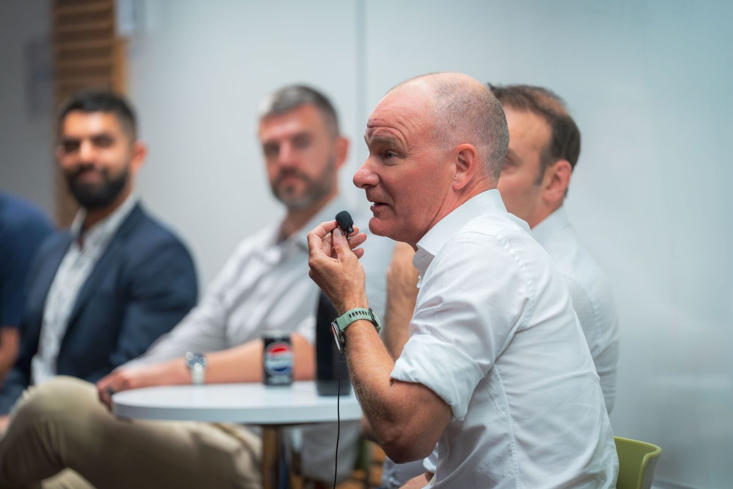 Speaker actively engages in discussion during professional panel event.