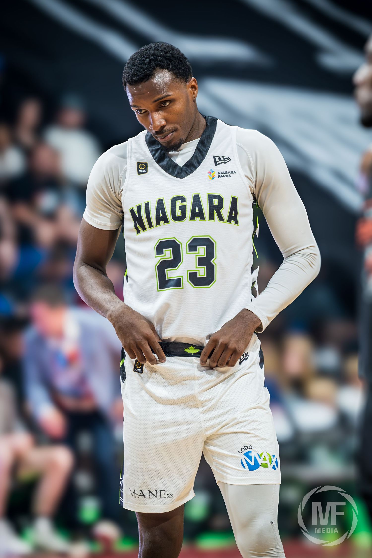 Niagara basketball player wearing jersey number 23 adjusting uniform on court during a professional game.