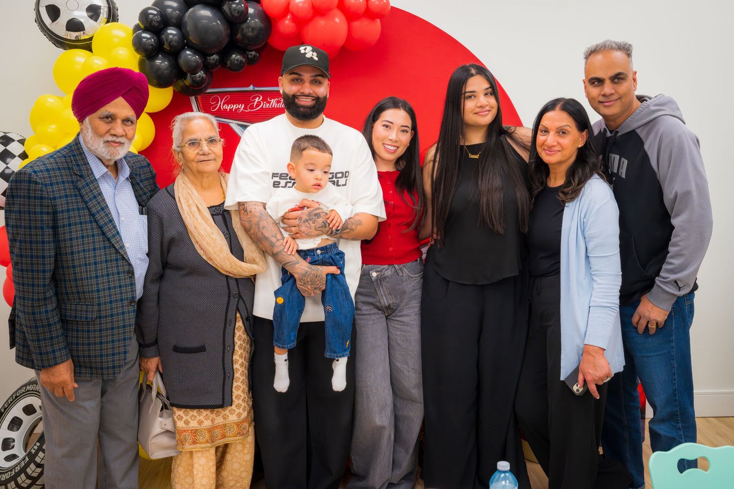 Large family group photo at a Mickey Mouse themed first birthday party celebration.