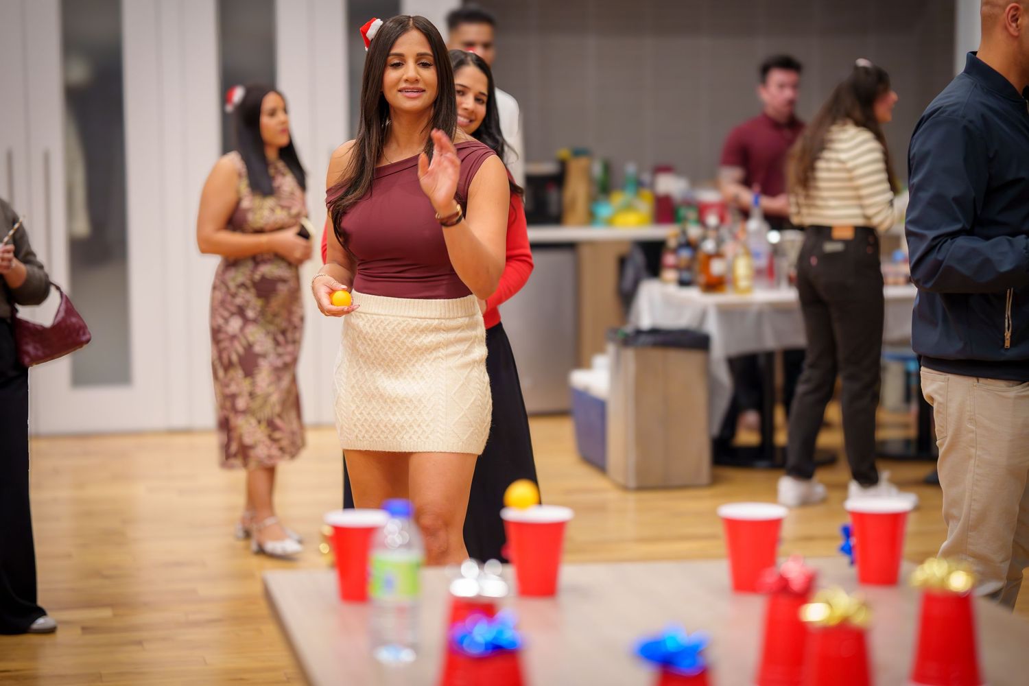 Party setup with plastic cups lined up on floor for group activities.