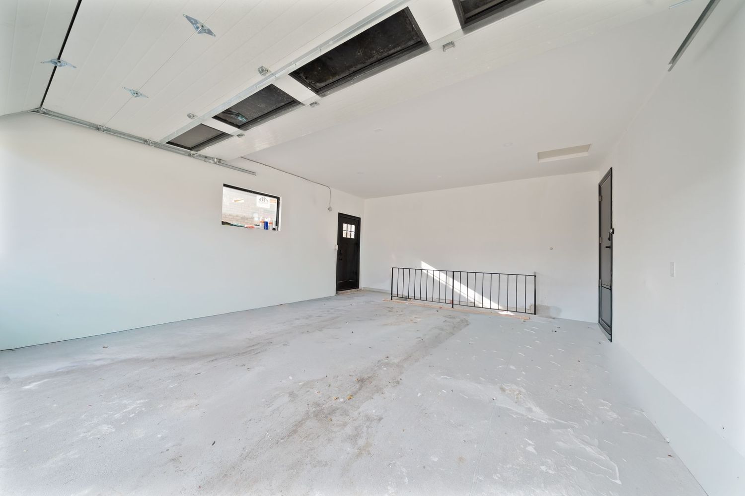 Interior view of a modern white staircase with curved walls and minimalist design features.