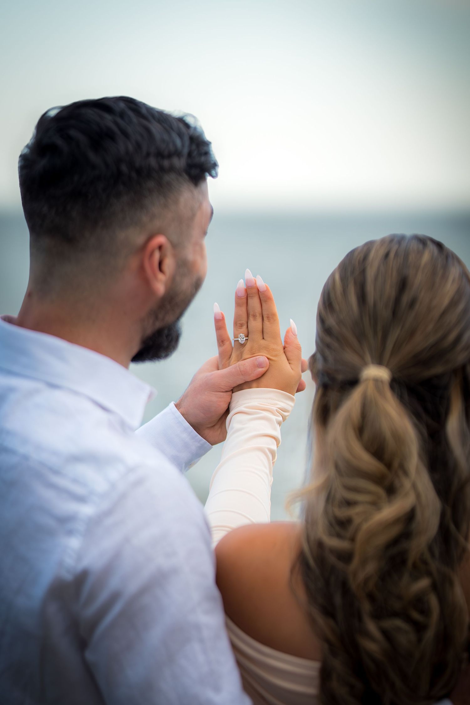 Side profile view of couple in formal attire during sunset.