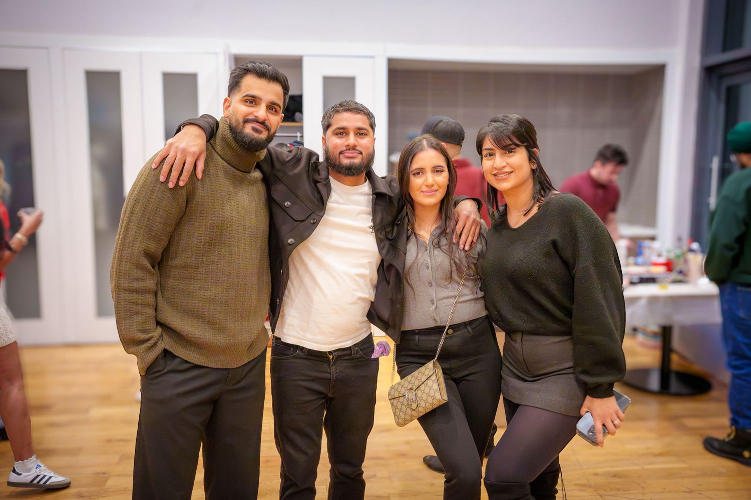 Group photo of party attendees standing together at an indoor event.