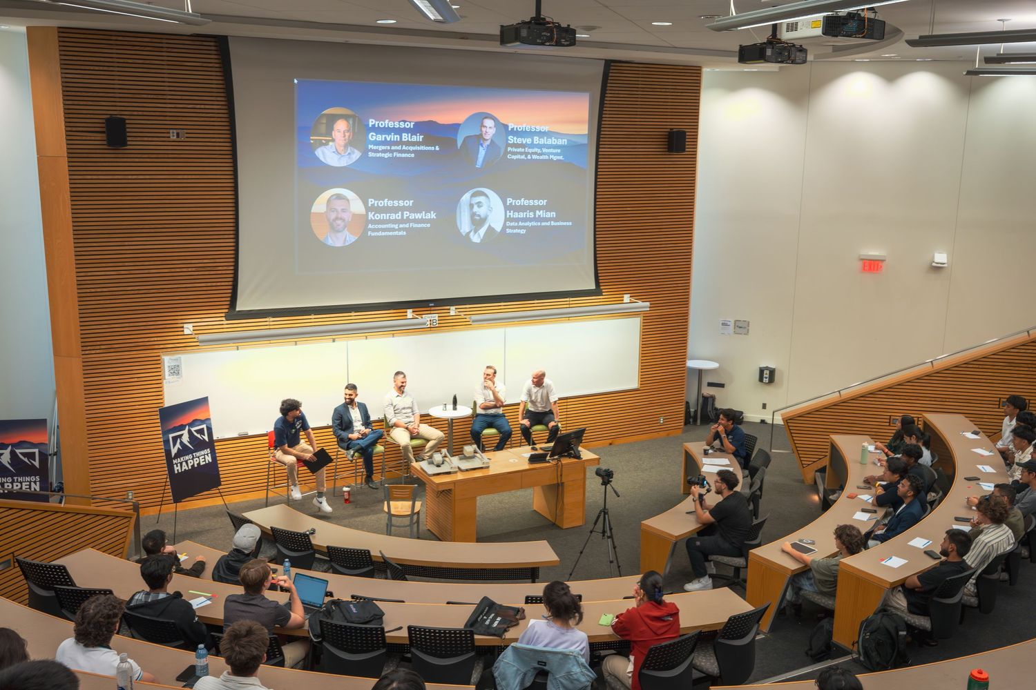 Panoramic shot of a university lecture hall during a business presentation.