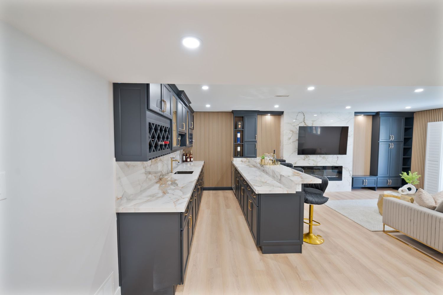 Modern office interior with wood floors and white walls features recessed lighting and sleek minimalist design elements.