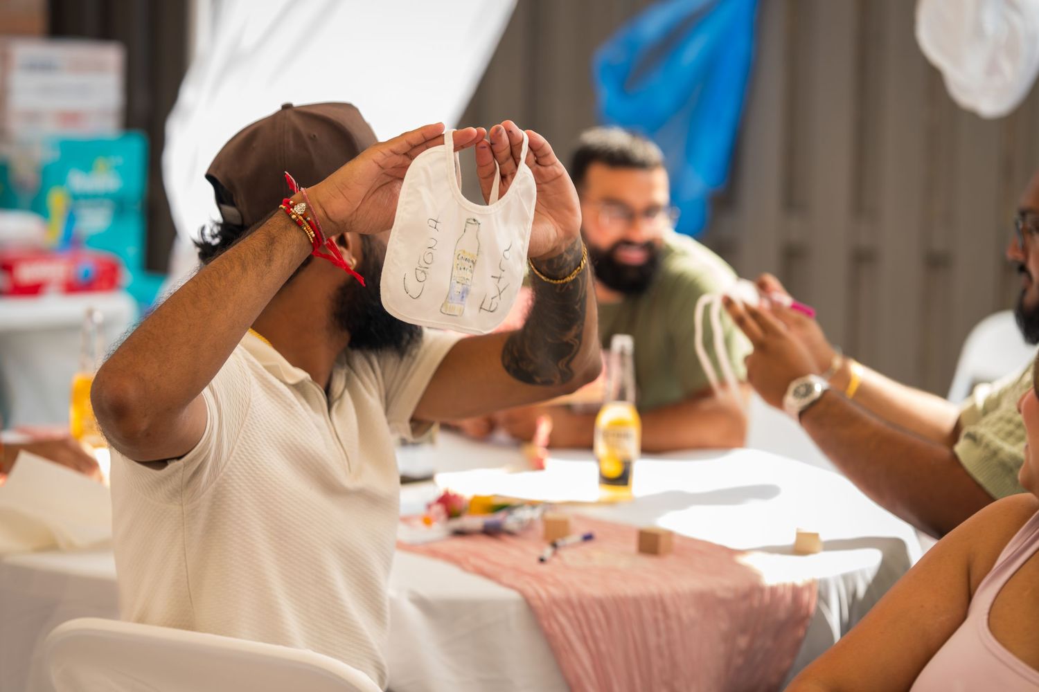 People engaged in conversation at a formal dining event with white table settings.