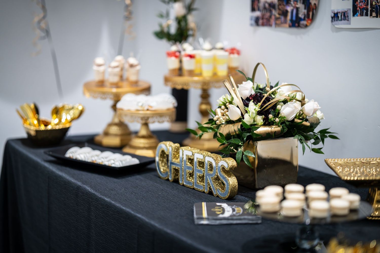 Elegant dessert table with gold platters and decorative treats at a formal event.