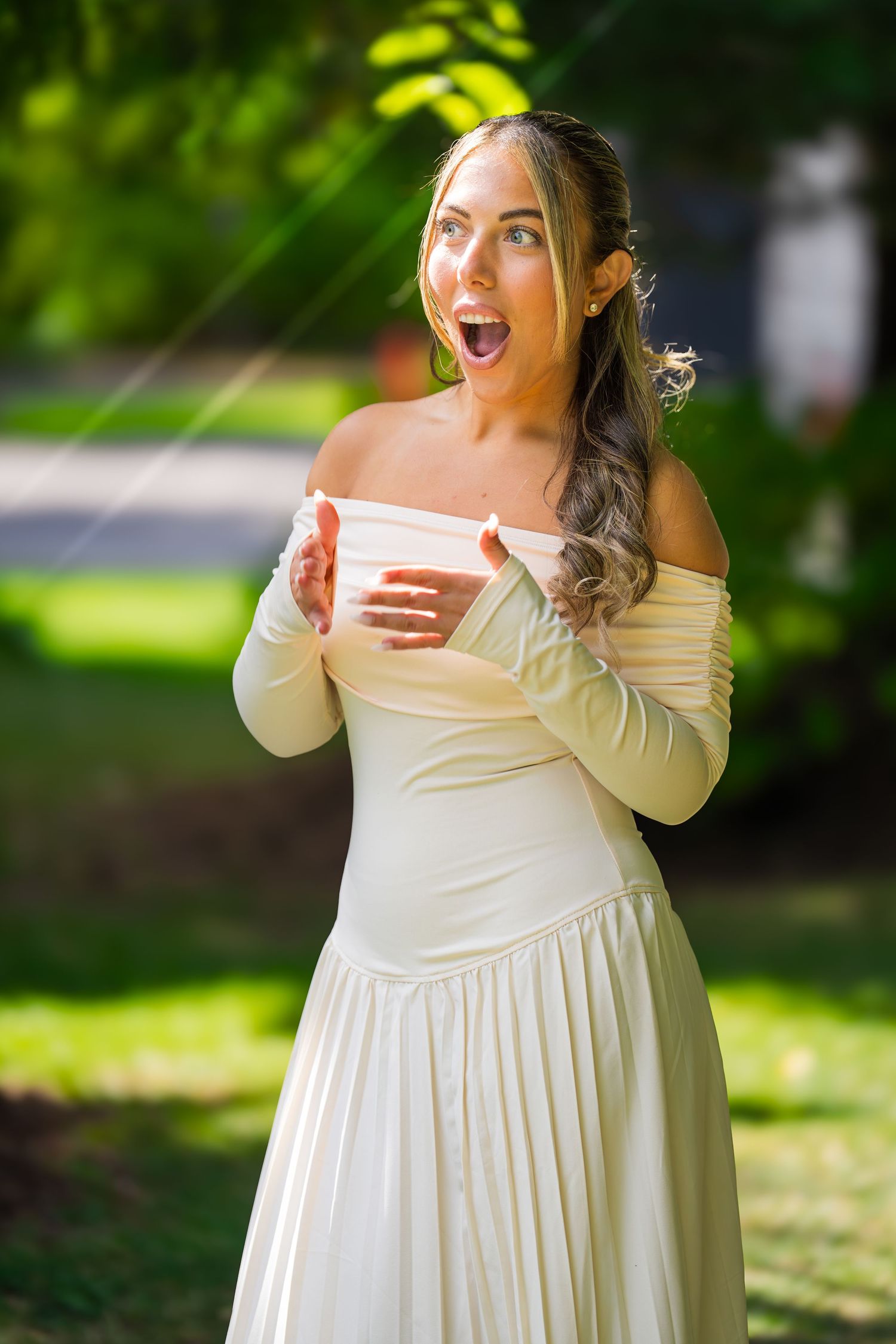 Candid expressions of joy and surprise photographed in a sunlit garden.