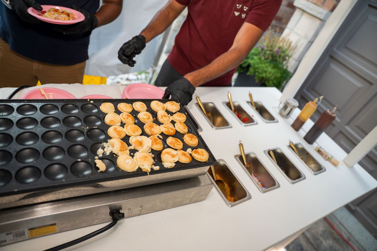 Professional dessert preparation station with organized rows of treats being assembled.
