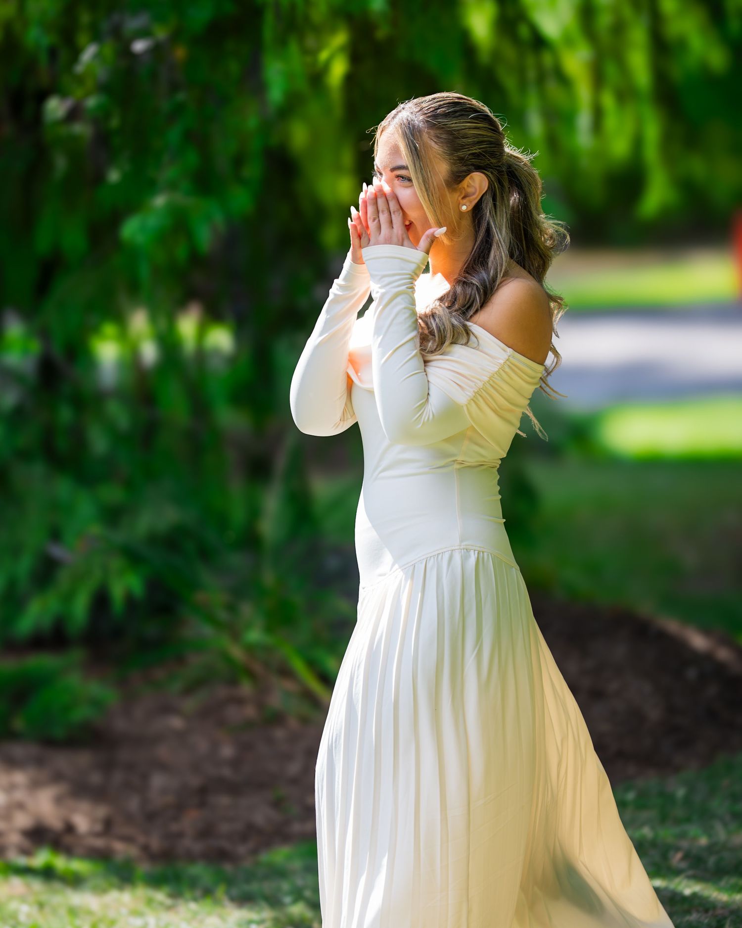 Emotional reaction captured in garden setting with natural greenery backdrop.